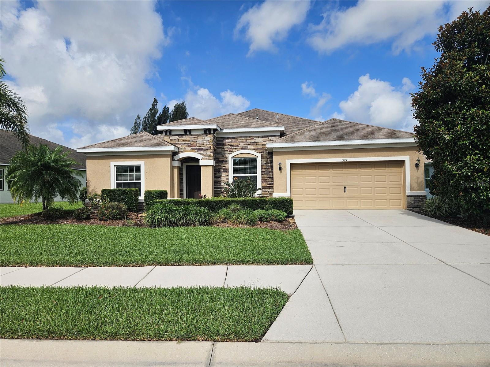This spacious 4-bedroom, 3.5-bath home with a 3-car tandem garage sits in one of Lakewood Ranch's most sought-after school zones and is loaded with thoughtful, high-end finishes throughout. The custom details set this home apart: a brand-new AC (2026), tankless water heater, floor-to-ceiling custom cabinetry, under and over cabinet lighting, contemporary beadboard and shiplap on walls and ceilings, crown molding, built-in closet systems, and designer paint. For movie nights or game day, a mounted projector and 135" screen are included with the home. The flexible layout offers something for everyone. The den/office features custom built-in cabinets and sliding pocket doors, making conversion to a fifth bedroom straightforward. One of the secondary bedrooms functions beautifully as a second primary or private guest suite, complete with a large sitting area, en-suite bath, and walk-in closet. Out back, the home borders a conservation area — a permanent wooded backdrop with no rear neighbors. Greyhawk Landing delivers resort-style amenities: two pools, a fitness center, basketball and tennis courts, a playground, a stocked fishing pond, and miles of walking and hiking trails. At this price per square foot, the value here is hard to beat.
