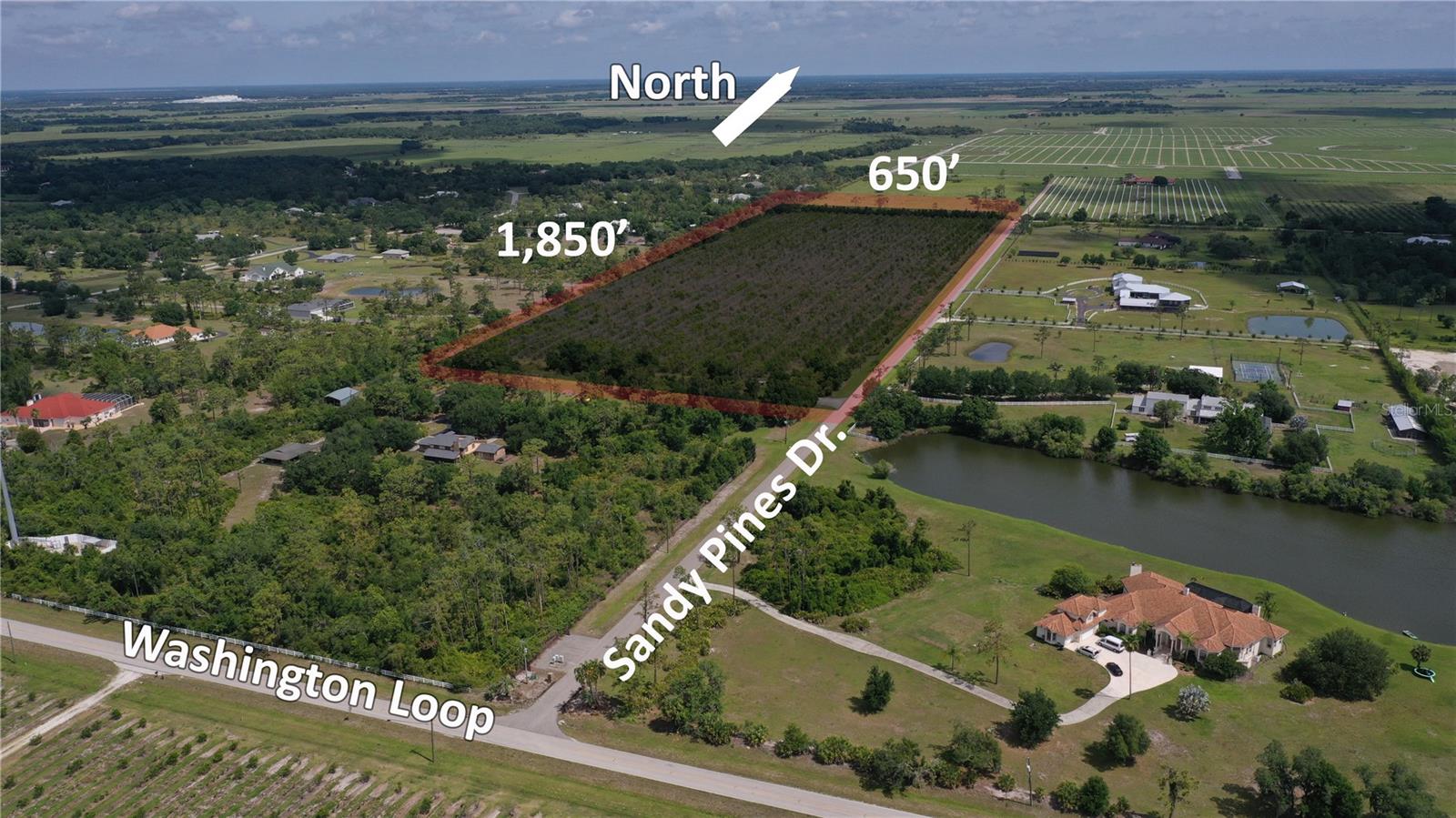 Vacant land parcel located on Sandy Pines Dr. in Punta Gorda, Florida, in the Washington Loop Shell Creek Area. The property offers approximately 1,850 feet of frontage with 650 feet of depth, providing significant development potential in this growing region.