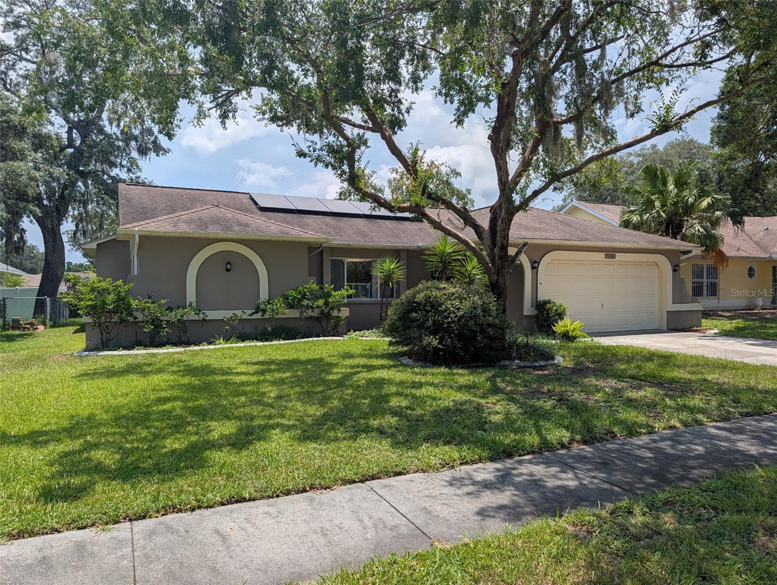 Welcome to Woodridge Estates. This 3-bedroom, 2-bathroom block home features a 2-car garage, vaulted ceilings, and an open floor plan with a combined living and dining area. The property includes a split-bedroom layout, a large fenced backyard, and a washer and dryer. Significant updates throughout the home include new flooring, solar panels, and a reclaimed water irrigation system. Located just minutes from downtown New Port Richey, you will have easy access to a variety of restaurants, shops, and entertainment.