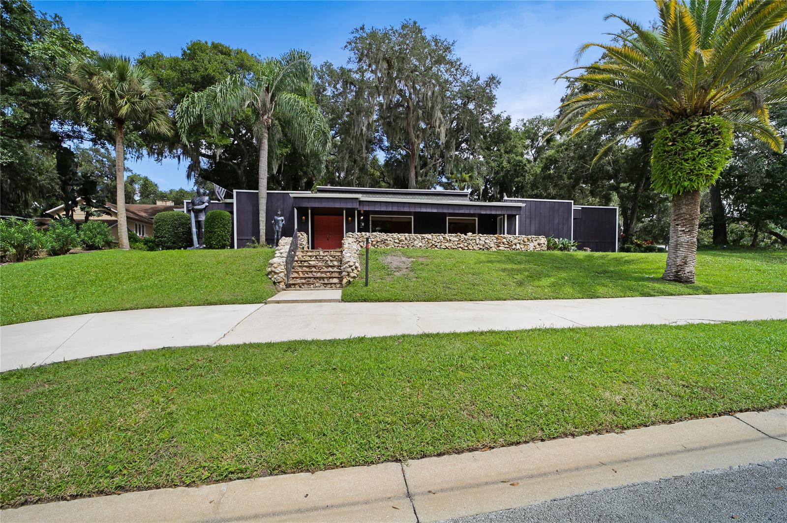 Unique Contemporary Showplace in Tomoka Oaks Subdivision, Great location with both a circular driveway and a garage entrance that opens to a cul-de-sac Great Ormond School Zone. Tongue and groove ceilings above a natural stone fireplace. Enjoy the breezes from the Tomoka River just a block away. Large split bedrooms, gorgeous trees and there is not a more convenient location in the Ormond Beach Area.