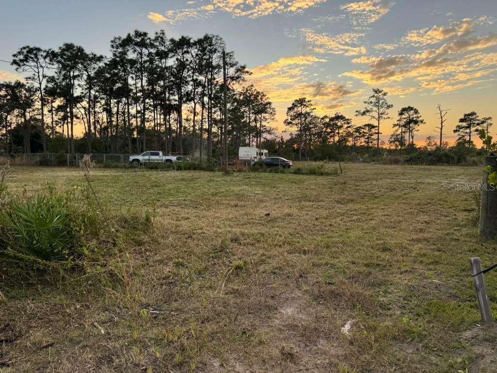 Vacant and undeveloped land located on Owens Rd, St. Cloud, FL 34773 — an excellent opportunity for investment or future development in the peaceful Harmony / Bull Creek area. This property offers approximately 1.55 acres of flat land with no immediate building restrictions, dirt road access, and nearby electric service availability. Situated in a quiet rural setting, the lot provides a private, serene, and spacious environment, ideal for building a custom home, placing a manufactured home, or holding as a long-term investment. The property is zoned OAC (Open Agricultural / Residential), allowing for a variety of potential uses (buyer to verify with local authorities). The lot is not waterfront and will require a well and septic system. With its generous size and strategic location near outdoor recreation areas, this property is perfect for those seeking rural living with convenient access to St. Cloud amenities and Osceola County services.