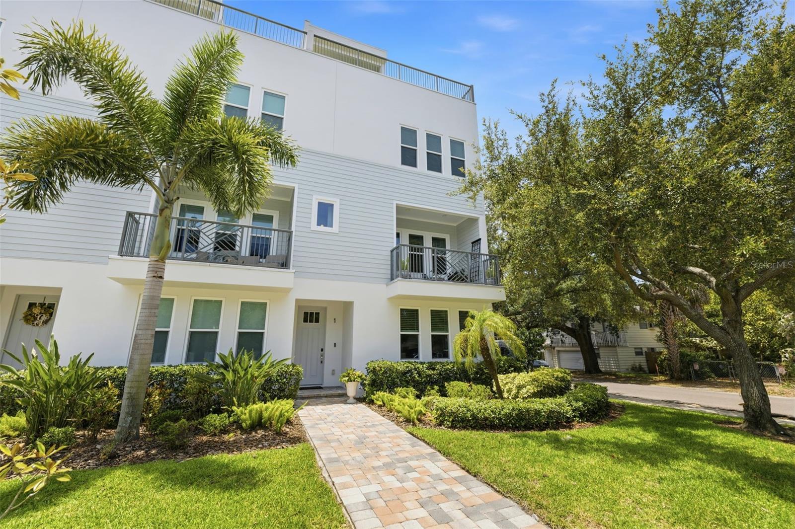 Experience elevated South Tampa living in this beautifully appointed end-unit townhome offering 3 bedrooms, 3.5 bathrooms, and an exceptional blend of luxury, functionality, and location. Thoughtfully designed with walnut hardwood flooring throughout, this home features an open-concept floor plan filled with natural light. The chef's kitchen is equipped with quartz countertops, a gas range, stainless steel appliances, and generous prep and storage space, flowing seamlessly into the living and dining areas. Step outside to the private balcony off the living room - perfect for morning coffee or evening relaxation. The spacious primary suite serves as a private retreat with a custom closet system and a spa-like en-suite bathroom featuring ample space to unwind. Each additional bedroom offers its own en-suite bathroom, making the home ideal for guests, family, or a home office. Designed for effortless entertaining, the top floor includes a custom bar complete with a wine refrigerator before leading to the expansive rooftop terrace. Outfitted with brand-new, professionally installed artificial turf, this incredible outdoor space showcases stunning views of the downtown Tampa skyline and provides the perfect setting for gatherings, sunset cocktails, or quiet evenings under the stars. Additional highlights include a two-car garage, newer AC handler for the main portion of the home, UV lights installed in the AC handlers, and a recently painted exterior for added peace of mind and curb appeal. Residents also enjoy access to the community pool. Ideally located just a short walk from Bayshore Boulevard and less than five minutes from Hyde Park Village, Barcelona Wine Bar, Oku, CAMP, and many of South Tampa's most beloved restaurants and boutiques. Situated within the highly sought-after Plant High School district, this home offers the perfect combination of luxury, convenience, and an unbeatable lifestyle.