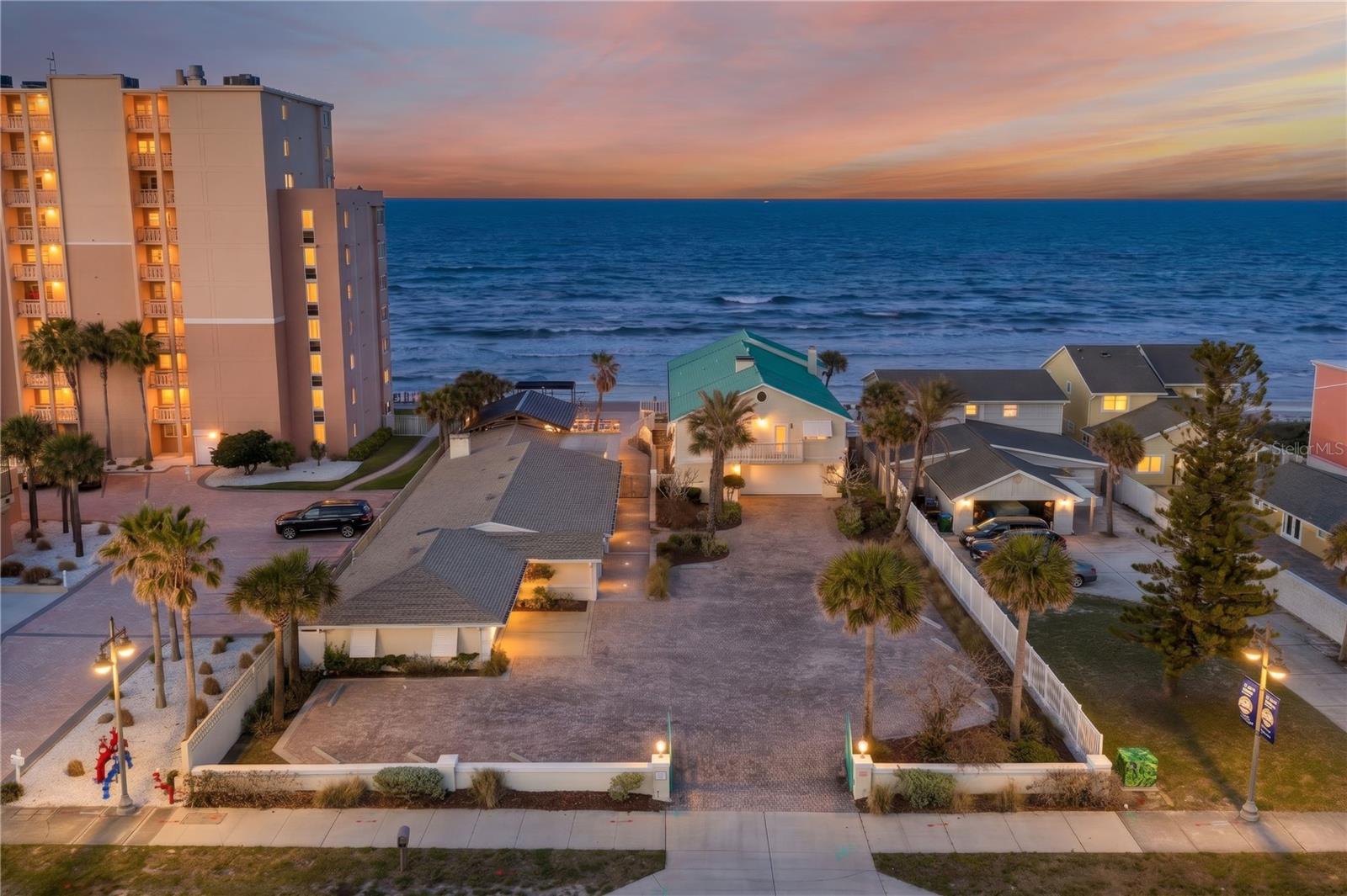 Rare 100' Wide Oceanfront Compound in Daytona Beach Shores! This executive-level estate features two distinct residences totaling 8,000+ sq. ft. of luxury living directly on the traffic-free sands of the ''World's Most Famous Beach.'' Whether envisioned as an elite corporate retreat, a multi-generational family sanctuary, or a primary residence of distinction, this one-of-a-kind coastal gem provides an unmatched Florida lifestyle full of flexibility and fun. Entertain or unwind from the sprawling beachfront swimming pool area that feels like a private resort, and enjoy the peace of mind of a new sea wall (2023). The northern, single-story home (3837 built in 1963) provides five bedrooms with a large oceanfront living area. Inside you will find plantation shutters, a fireplace, and an open kitchen with granite counters, stainless appliances and a welcoming breakfast bar. Hurricane shutters and a new A/C were installed in 2024, while the new covered patio, featuring salt-resistant

Mississippi Cypress, may be your favorite place to escape the sun for a bit. The southern residence (3839 built in 1979) is two-stories with spacious living areas, six bedrooms, and multiple balconies. Here you will discover stunning woodwork, crown molding, a fireplace, and a stylish, winding staircase. The primary suite enjoys an oceanfront balcony with panoramic views of the Atlantic coastline. Recent upgrades to this property include a hurricane resistant roof with a standing seam color impregnated aluminum (2022) and new a/c (2022) and electric hurricane shutters. With both homes featuring oversized, two-car garages and plenty of space in the large open driveway, parking should never be an issue. There are too many features and upgrades to list, making this one of those properties you have to experience in person to truly appreciate. If you're ready for unparalleled paradise in Central Florida, you can't miss this one! Any stated measurements, square footage, and lot dimensions are approximate and provided for informational purposes only. Buyer shall rely solely on their own due diligence and verification.