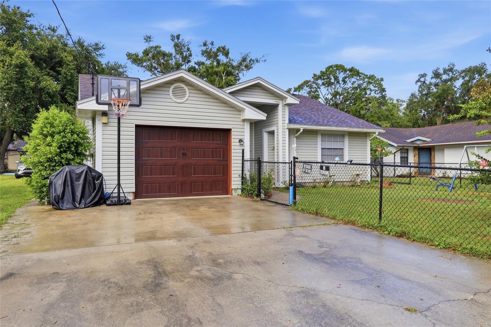 No HOA, No CDD, Low Property Taxes!  Are you looking for a 3 bedroom 2 bath home with a new shingle roof , new A/C system, newer water heater, granite countertops in the kitchen with new cabinetry and breakfast bar?   What about laminate flooring throughout the entire home?  No carpet here!  Check all of the boxes with this charming home in mind.  Beautifully remodeled bathrooms! You've got to see the personality of this home! Additional features include a bay window in the dining area, French doors from the living room and primary bedroom out onto the screened lanai.  More special features include a solid wood front door and new wood-look garage door with cedar trim. Have you heard of PEX pipe?  It doesn't rust, pit, or build up with mineral scale so check that box as well! This property has partial chain link fencing in the front, paved road frontage in both the front and the rear of the home.  Need outdoor storage? The storage shed stays and has a new metal roof with built-in shelving inside.  Priced right and welcome creative financing! With all of these upgrades we're expecting to go pending quickly. Showings are by appointment only.