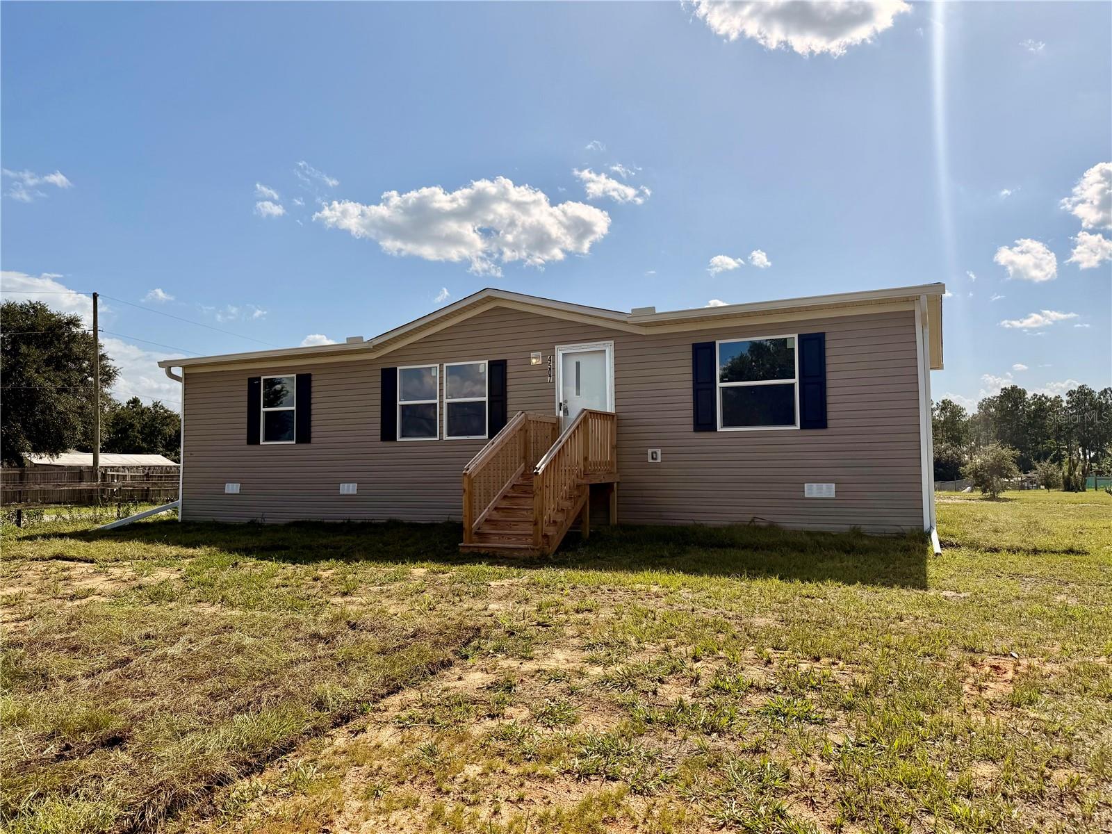 MOVE IN READY! Introducing this brand new 2026 doublewide home that sits on almost an acre of land. Located in a quiet rural setting but still close to town amenities. This beautiful property offers all new appliances that include a refrigerator, stove, dishwasher, washer, and dryer. The kitchen offers plenty of cabinet space and an island. There is a walk-in closet in every bedroom and you'll find that the rooms are a comfortable size. One of the best features of this property is that you only have to pay for the electric bill as this home has a septic tank and a well.This is definitely a must see home! Lawn care will be provided once a month and pets will need to be approved by the owner. First month rent and security are required to move in.