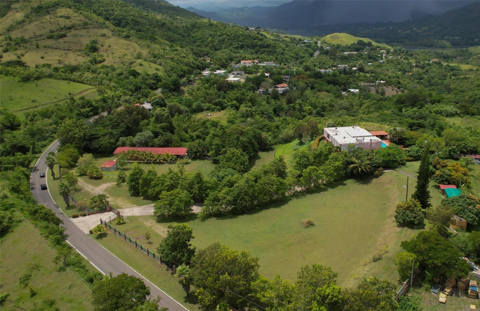 SELLER FINANCING AVAILABLE – ACT 60 TOURISM INCENTIVES OPPORTUNITY

Just 1 hour and 15 minutes from San Juan.
Hacienda Don Pedro Refined Caribbean Ranch Meets Classic Puerto Rican Hacienda
An Estate Rooted in Heritage, Designed for Lifestyle
Step into a property where heritage, design, and natural beauty come together in perfect harmony. This extraordinary Puerto Rican hacienda captures the essence of a colonial ranch-style estate, elevated with tropical countryside charm and designed for those who appreciate authenticity, space, and lifestyle.
?? Hacienda-Style Highlights
Colonial Hacienda Layout
The heart of the home is a traditional layout inspired by Spanish colonial estates—featuring a spacious central living room, soaring double-height ceilings, gallery-style balconies, and an elegant flow that brings light and warmth throughout.
Rustic and Equestrian Influences
A covered stable and gathering area reflects the property's equestrian soul. Terracotta tones, wrought iron accents, and saddle décor blend rustic function with refined charm, offering the perfect space for both horse lovers and event hosts.
Expansive Grounds with Natural Flow
The aerial perspective reveals manicured landscapes, a tree-lined private driveway, open green pastures, and carefully placed structures. The gently sloping terrain embraces the hacienda, ideal for agricultural ventures, a boutique guesthouse, or a serene private retreat.
Traditional Materials
The estate is grounded in timeless design—terracotta tile floors, solid wood finishes, hand-forged ironwork, and sturdy columns speak to Caribbean craftsmanship and enduring quality.
Indoor-Outdoor Living
Enjoy effortless flow from indoor spaces to open-air patios, a swimming pool surrounded by greenery, and shaded gathering spots. The home is made for entertaining, relaxing, and celebrating Puerto Rico’s year-round beauty.
Authentic Interior Touches
Rich textures, vibrant color palettes, handcrafted details, and curated artwork celebrate Puerto Rican culture and lend every space a sense of soul and story.
________________________________________
This is more than a property—it’s a lifestyle sanctuary. Whether envisioned as an equestrian ranch, a boutique bed & breakfast, or a multigenerational compound, this estate invites you to live with purpose and beauty in the heart of Puerto Rico.