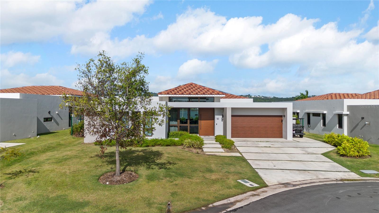 One or more photo(s) has been virtually staged. Location and front lake, golf view, overlooking El Yunque Rainforest are only one of the best characteristic of this modern one level home. In the heart of Palmas Del Mar Resort in Humacao, Puerto Rico, this spectacular, fully equipped NEW property, will satisfy all needs for a family looking for peace, elegance, luxury, comfort and more. Pictures don't do justice to the beautiful well maintained property, the landscaping, the amazing sunsets with pink skies, the modern kitchen with open concepts, the covered high ceilings terrace, is just the beginning when you come tour this house. Each of the four bedrooms are beautifully decorated to the last detail. The Master Bathroom is unique, Master Bedroom Closet has enough space for his and hers, Kitchen appliances are Monogram, there is even a removable gym in the garage with a dedicated AC Unit. The house has generator, eight AC split units, solar water heater, 4 bedrooms, 3.5 bathrooms, dinning room, living room, family room, fully equipped kitchen and more. Los Lagos at Palmas is the only new construction development in Palmas Del Mar. Los Lagos Club House is located walking distance to this house and you can enjoy there a modern Fitness Center, Infinity Pool, Hot Aqua therapy pools, luxury event venue and mini golf. There is a second Club House under construction with 3 pickle ball courts, 24 parking spaces, kids playground and more. Palmas Del Mar Resort has a Beach Club, tennis center, fitness center, dog park, kids park, golf, hotels, many restaurants and more. Here you can find the Resort Lifestyle your family and you deserve. This property is available for showings now and ready to be delivered in Summer.