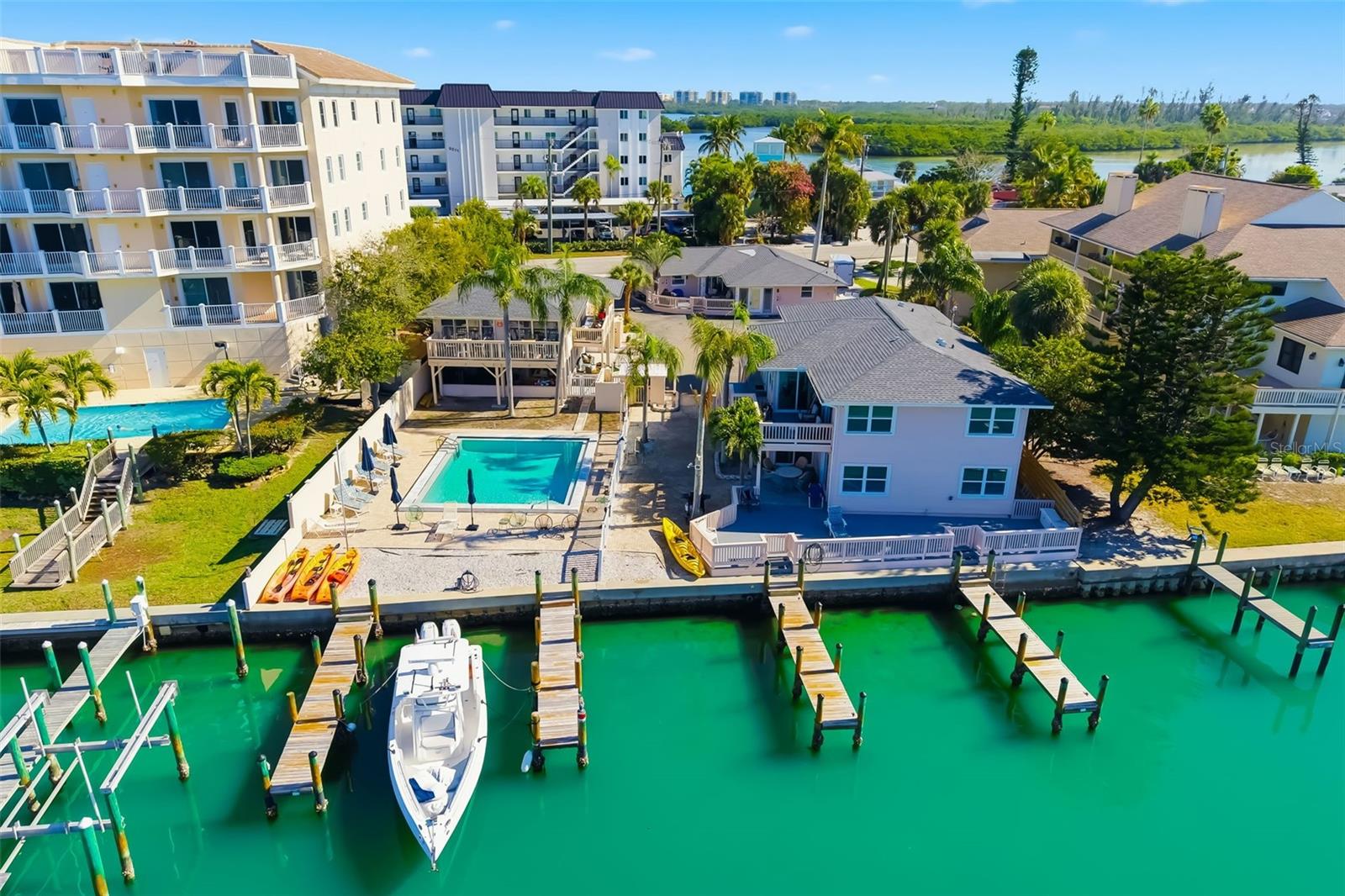 Under contract-accepting backup offers. An exceptionally rare opportunity to acquire a fully renovated, income-producing, nine-unit, waterfront condominium complex located
adjacent to Turtle Beach on world-renowned Siesta Key. Coral Shores offers immediate short-term rental income opportunity, paired with long-term redevelopment and appreciation potential, in one of Florida’s most supply-constrained coastal markets. 

Property Highlights:
• Nine (9) condominium units sold as a package
• Just under 0.50-acre waterfront site
• Direct Sarasota Bay to Gulf of Mexico access – no bridges
• Four private docks with eight slips (up to ~40’+ vessels)
• Heated in-ground swimming pool
• Large central parking lot for tenants and guests
• Shared laundry and owner storage facilities
• Predominantly 2BR units with select 1BR and studio layouts

Renovations & Interior Upgrades: 
All units have recently completed extensive renovations featuring modern coastal interiors, updated kitchens with new appliances, stone countertops and new cabinetry, glass-enclosed contemporary bathrooms, new flooring, trim, windows, and select in-unit laundry, new common pay laundry appliances with storage closets, new raised HVAC units, new pool pump equipment, and more. The property is fully turnkey for continued short-term rental use. 

Income & Zoning Upside: 
Currently operating as weekly short-term rentals with strong seasonal occupancy. Zoned for low-rise condominiums (2–3 stories), with surrounding properties zoned mid-rise (4–6 stories), providing future redevelopment or density expansion potential subject to approvals.

More detail is available with executed NDA.