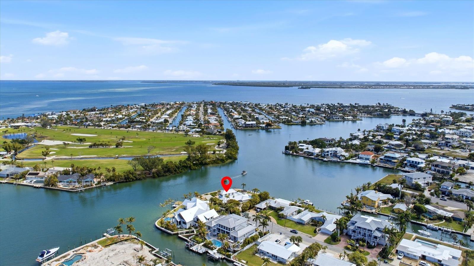 Under contract-accepting backup offers. Spectacular bay views define this recently renovated 4-bedroom, 4-bath waterfront home in Holmes Beach, set on a large bayfront lot with exceptional waterfrontage and sweeping open water vistas. Positioned at the end of a quiet bayside street, the property captures some of the most expansive bay views on Anna Maria Island. Renovated within the past year, the home blends updated finishes with distinctive architectural details and inviting gathering spaces. The main living area features a wood burning fireplace, while large windows and sliding glass doors frame the bay and fill the home with natural light. A tongue-and-groove wood ceiling adds warmth and coastal character throughout the primary living space.

The updated kitchen includes built-in appliances, custom cabinetry, and generous prep space, opening to the dining and living areas for easy entertaining. A standout feature is the second-floor great room, an expansive and versatile retreat offering elevated water views and abundant natural light. The space includes 4 day beds, a full bath, and an adjacent artist space, creating flexible accommodations for guests or creative pursuits.

Outdoor living takes full advantage of the setting with a private pool and expansive waterfront patio areas overlooking the bay, providing ideal spaces for lounging, dining, and enjoying coastal breezes and stunning sunsets.

Located just moments from the beaches, shops, and restaurants of Anna Maria Island, this property offers recent renovations, generous living spaces, and exceptional bayfront views in one of Holmes Beach's most desirable waterfront settings.