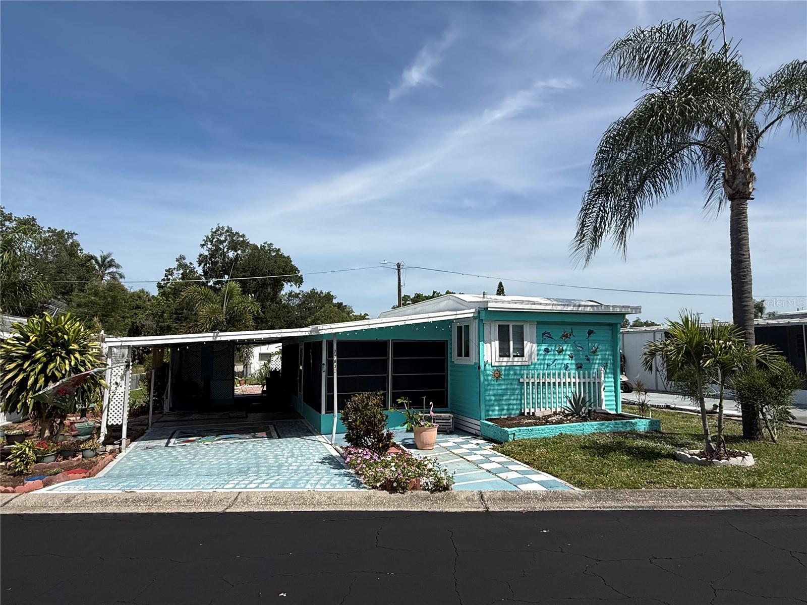 Welcome to 7703 Audrey Lane, a charming and comfortable home located in the well-established Terrace Siesta Mobile Home Park, a 55+ community, right in the heart of Ellenton with convenient access to US-301 and Erie Road.

This 2-bedroom, 1-bath home offers a functional layout with a warm, lived-in feel and plenty of character throughout. One of the standout features is the large enclosed front porch, complete with its own A/C, providing additional living space that can be used as a sitting area, hobby room, or a relaxing spot to enjoy your morning coffee year-round.

Inside, the home features a comfortable kitchen with ample space for daily use, along with a layout that flows easily from room to room. The home has been cared for and offers a welcoming atmosphere with personal touches throughout, making it feel inviting from the moment you step inside.

Outside, you’ll find a covered carport with plenty of parking, along with a storage shed under roof that includes power and shelving—ideal for tools, storage, or workspace needs. The property also includes a private hot tub that is currently operational, adding an extra feature for relaxation and enjoyment.

The location is a major highlight. This golf cart-friendly community places you within close proximity to Creekside Commons, where you’ll find Publix, Lowe’s, restaurants, banking, and everyday conveniences just a short ride away. Ellenton Premium Outlets are located approximately one mile down the road, and I-75 access is nearby, making travel to surrounding areas quick and convenient.

Terrace Siesta Mobile Home Park offers a variety of amenities for residents, including two clubhouses, two swimming pools, shuffleboard courts, a dog park, and an on-site laundry facility. The community provides a well-established setting with shared spaces designed for recreation and convenience.

This home presents a great opportunity for someone looking for a comfortable, manageable space with added features and a strong location. With its enclosed porch, outdoor amenities, and proximity to shopping and major roadways, it offers a combination of practicality and lifestyle.

Buyer and buyer’s agent to verify all measurements, community requirements, and any restrictions directly with park management.