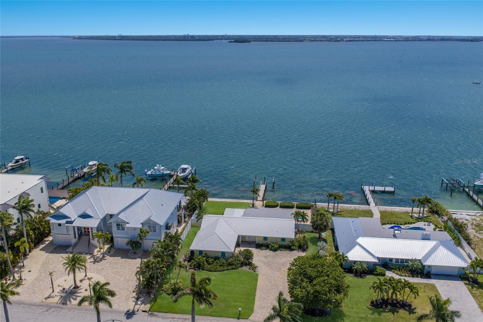 FULL INTERCOASTAL WATER VIEWS!!! A rare waterfront opportunity awaits on beautiful Anna Maria Island. Set on an oversized homesite along Key Royale Drive, this exceptional property offers the perfect canvas to build your island dream home.
The backyard is a tranquil retreat offering world-class sunrise views over the intercoastal waterway, along with direct fishing and boating access to the Gulf. Just down the street, the Key Royale Club features a private 9-hole golf course, dining, and social amenities. You’re also only a short golf cart ride away from Anna Maria Island’s top-rated restaurants, boutique shopping, and pristine white-sand beaches.
The existing 3-bedroom, 3-bathroom home sustained water damage from Hurricane Helene and has been partially gutted, providing a clean slate for redevelopment. The spacious backyard already includes a sparkling pool, private dock, and room to add a boat lift — an ideal foundation for waterfront living.
Whether you’re seeking a full-time residence, luxury vacation home, or investment property, the possibilities here are endless!