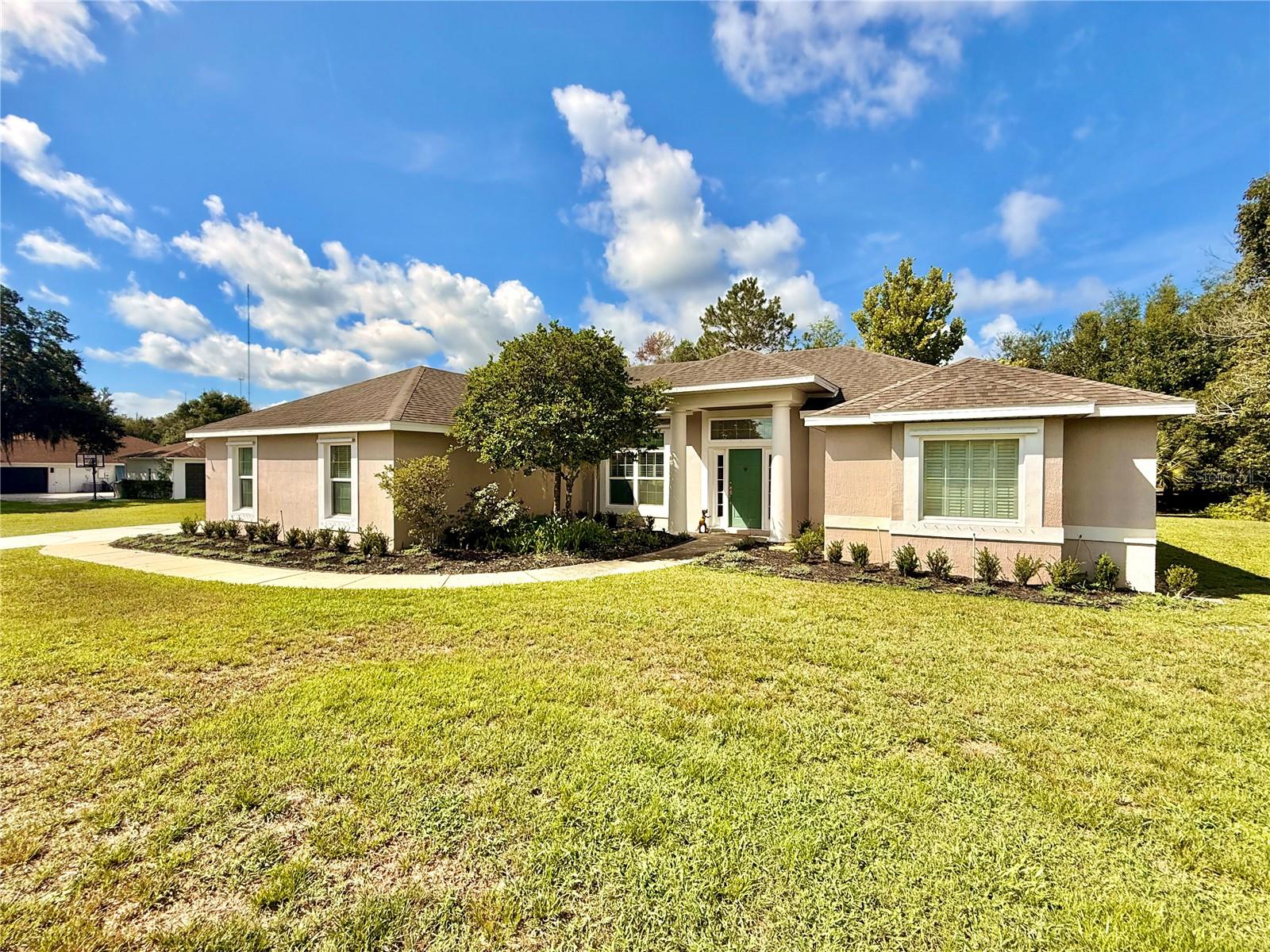 Pictures coming 7/14. Where comfort meets capability. Nestled on nearly 1.25 acres in the highly sought-after Pickett Downs, this impeccably maintained 4-bedroom, 3-bath ranch-style residence offers 2,777 square feet of thoughtfully designed living space, combining timeless comfort with exceptional functionality. Step inside to discover soaring vaulted ceilings, an inviting open-concept floor plan, and elegant large-plank imported Italian porcelain tile that flows throughout the main living areas. The spacious kitchen seamlessly overlooks the living and dining spaces, creating an ideal setting for entertaining or everyday living. The private split-bedroom layout provides excellent separation, while the expansive primary suite serves as a true retreat, complete with a beautiful tray ceiling, generous proportions, and a spacious en-suite bath. A versatile 400-square-foot flex space with dedicated min-split cooling system offers endless possibilities as a home office, media room, fitness studio, playroom, or guest retreat. Outside, the property truly shines. Situated beneath mature trees on a beautifully maintained homesite, you'll find an impressive 30' x 30' drive-through workshop featuring 9-foot doors, ample room for multiple vehicles, boats, recreational equipment, or hobbies, plus an attached exterior storage area ideal for landscaping equipment and tools. The workshop also includes a conveyed secondary refrigerator, wall vacuum system with hoses, custom fitted hurricane protective covers for exterior windows, riding lawn mower, and large capacity air compressor. The back door leads to a spacious fenced dog run providing the perfect place for pets to roam safely while preserving the expansive yard as well as the inclusion of an elevated grill and patio area offering the perfect hub for outdoor entertaining. The home also includes a well maintained 22kW Generac Whole Home system powered by 500 gallon propane tank for up to 2 weeks of secondary power needs, a deep water well, and home water softening system. Enjoy deeded access to the highly desirable Lake Pickett. Whether you’re into fishing, wakeboarding, pontoon cruising, paddle boarding, or jet skiing, this low traffic spring-fed oasis is a significant benefit to any water enthusiast. Whether you're seeking room to spread out, space for your toys and projects, or simply the peace and privacy that acreage living provides, this exceptional property delivers—all while remaining conveniently located near shopping, dining, top-rated schools, and major commuter routes. Energy Star Low E windows added 2016, A/C 2024, A/C mini-split 2024, new roof 2016, and septic pumped out May 2026. This is a rare opportunity to own a meticulously cared-for estate property where luxury, practicality, and country charm come together in one extraordinary package.