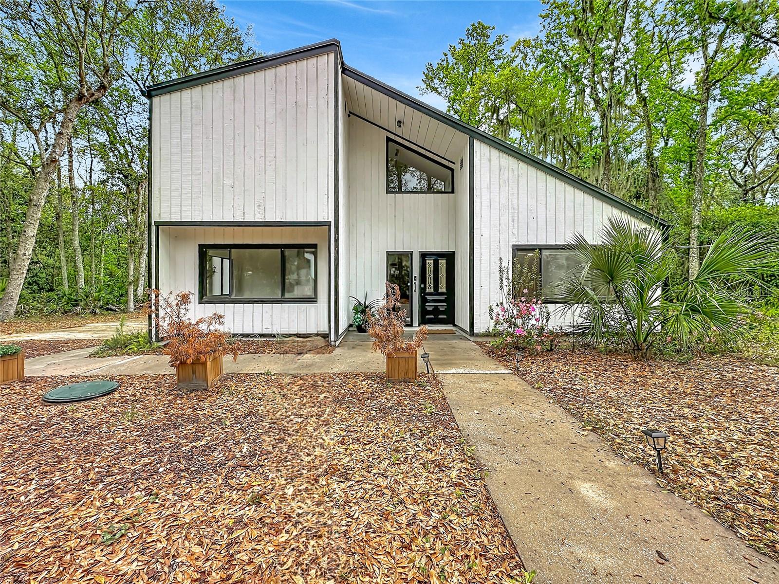 Step into timeless design with this stunning mid-century modern custom home designed by renowned St. Augustine architect Howard Davis. Nestled on almost an acre, this 3,000 sq ft architectural gem features an open floor plan with vaulted ceilings, 2 spacious primary suites (one upstairs and one downstairs), 2 additional bedrooms, and a flex space room currently used as a bedroom--offering both flexibility and function. Extensively updated in 2024, this home blends classic style with modern peace of mind: new roof (Jan 2024), HVAC, water heater, water softener, updated electric panel, new culvert and concrete entry, fully renovated kitchen and living spaces, plus major tree trimming and removal of dead/dying trees--making this property truly move-in ready. Adding even more value and versatility, a self-sustaining Airstream is positioned on the front corner of the property--perfect as a guest suite, in-law quarters, or income-producing rental. Currently, both the main home and

Airstream are successfully operating as vacation rentals, offering an incredible opportunity for immediate income or multi-generational living.This one-of-a-kind property combines iconic design, modern upgrades, and endless possibilities--all set on a rare, expansive lot.