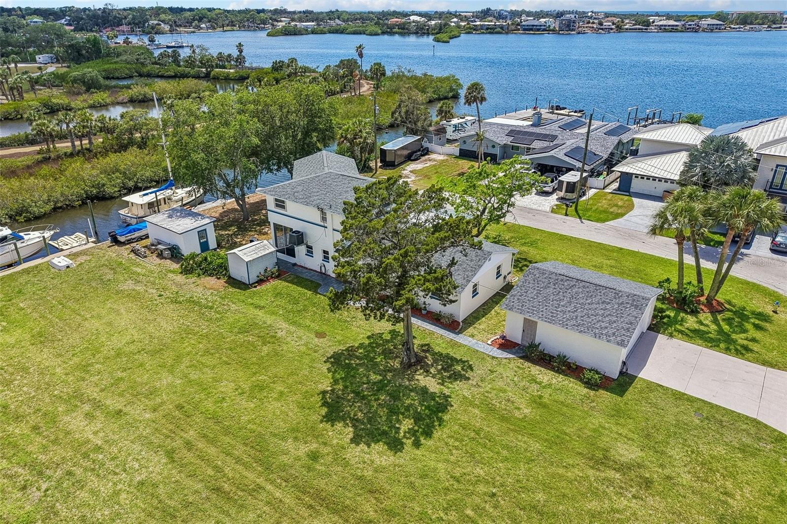 Waterfront - Gulf access, Experience the ultimate Florida waterfront lifestyle in this exceptional 3-bedroom, 3-bath residence nestled along the protected waters of Miller’s Bayou. Situated on an oversized 1.5-lot homesite with a city park bordering the south side, this property offers a combination of privacy, space, and boating convenience rarely found in today’s market.
Designed for those who appreciate life on the water, the protected harbor and private dockage can accommodate vessels of almost any size while providing the security and calm waters  boaters desire. Spend your days fishing, cruising  the Gulf, or even water-skiing right from your own backyard in beautiful Port Richey, Florida.

Inside, the home has been thoughtfully updated with a new roof and air cond in 2025, along with recently installed kitchen cabinetry, new appliances, and fresh interior and exterior paint. The spacious second floor overlooks the bayou and Gulf waters beyond, featuring a large bedroom, private bath, bonus room, and balcony that could easily serve as an in-law suite or private guest retreat.

Outdoor living and storage possibilities abound with a detached garage, workshop area, additional marina storage shed, golf cart parking, and room for multiple vehicles. A covered two-car carport plus detached garage space provide ample room for cars, recreational vehicles, boats, golf carts, or even RV storage right at home in this golf-cart-friendly community. The balcony looks west for those great sunsets nightly.  View the great white egrets fishing and the mullet jumping in this old Florida setting.

Located just a few blocks from popular waterfront dining, shopping, entertainment, and endless outdoor recreation, this one-of-a-kind bayou property delivers the true essence of upscale coastal living. Bring your boats, toys, and sense of adventure — this is a special waterfront retreat where every day is a vacation day.