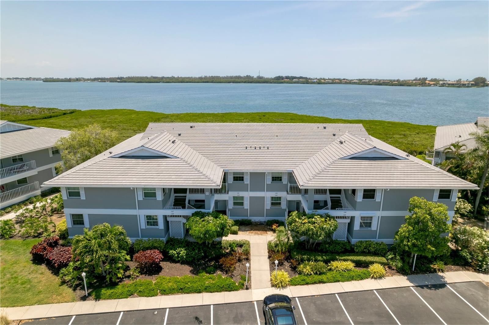 PERICO BAY CLUB – CONDO-BRADENTON- FOR SALE/LEASE OR POSSIBLE OWNER FINANCING AVAILABLE- Beautiful, turnkey, fully furnished 2 bedroom, 2 bathroom first-floor condo with breathtaking views of Palma Sola Bay and the intercoastal waterways. Nestled in the well-established gated community of Perico Bay Club, this condo combines luxury, comfort and convenience. Updated kitchen featuring custom "praline" solid maple cabinets, stainless steel appliances, quartz countertops, soft-close drawers all complemented by luxury vinyl flooring. The generous owner's suite boast picture-perfect waterfront views, a spacious walk-in closet, and an updated ensuite with dual vanities, seamless enclosed shower, and a heated towel rack. The condo also benefits with fresh paint, a new roof with retrofit 3rd nail
enhancing both insurance savings and providing extra wind and storm protection. Perico Bay Club offers an array of resort-style
amenities throughout this expansive community for you to be able to enjoy an active Florida lifestyle, including each neighborhood
having their own pool, a Clubhouse with an Olympic-sized pool, tennis and pickleball courts, shuffleboard, a fitness center, a library,
kayak launch, pier, new boardwalk and much more not to mention a full social calendar full of activities and events. Located just 2
miles from Anna Maria Island and a short bike ride to Robinson and Neal Reserve, this condo is perfectly situated for those who love
both relaxation and adventure. Don’t miss this opportunity to own a slice of paradise!