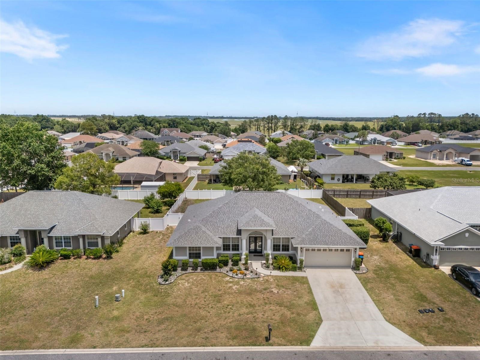 Located in the desirable Diamond Ridge community of Belleview with NO HOA, this well maintained 4 bedroom, 3 bath home offers 2156 living square feet on a 0.26 acre lot with a completely fenced in back yard. Built in 2007, the home features an inviting open layout with a triple split plan design, newer flooring throughout, updated 5-inch baseboards, and fresh interior paint. Triple sliding glass doors lead to the back lanai, creating an ideal space for relaxing or entertaining. The kitchen is in the heart of the home and overlooks the main living areas, while the spacious primary suite includes a custom built-in closet system and an updated en suite bathroom. Home has been maintained and the home reflects pride of ownership throughout. Recent improvements include a 2024 roof, 2020 4-ton HVAC system, 2020 water heater, and updated kitchen appliances. Walking distance to the Belleview Sports Complex and within the Belleview school district. With no HOA fees or deed restrictions, this property offers flexibility and comfort in a convenient location.