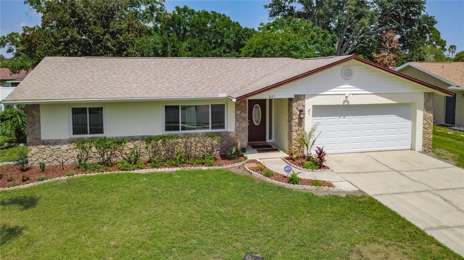 Move-in-ready Winter Park gem in top-rated Seminole County schools! This 3BR/2BA home features a private split-bedroom layout. The home features laminated wood flooring in all the bedrooms and beutiful tile in the kitchen and bathrooms. Both bathrooms feature newly updated toilets. 
The expansive eat-in kitchen is a chef's delight, boasting premium granite countertops, solid light maple cabinets with elegant glass upper doors, and a breakfast bar opening to the large family room.
 Enjoy total peace of mind with extensive 2023 upgrades, including a BRAND NEW ROOF, new electrical panel, new energy-efficient windows, new French doors, and a new garage door for the 2-car garage.The HVAC system was manufactured in 2019 and installed in 2020
 Step outside to a massive, fully fenced backyard featuring a large covered lanai with a brand-new aluminum frame and fresh screens—perfect for outdoor entertaining.  Truly a turnkey property optimized for insurance savings and modern comfort. Schedule your tour today!