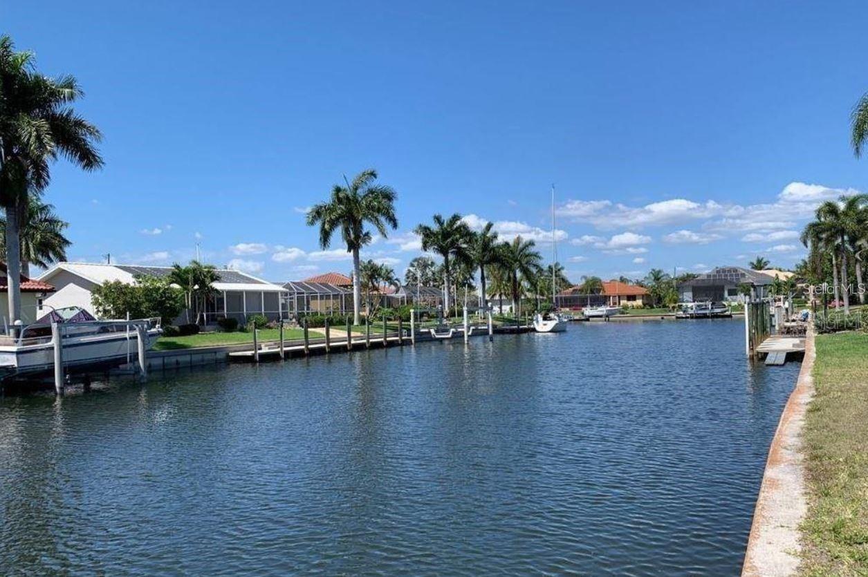 Fantastic 80x120 WATERFRONT lot with QUICK SAILBOAT ACCESS in the highly desirable community of PUNTA GORDA ISLES with wide canals (no less than 100 feet) and some of the best fishing & boating in SW Florida. This lot has an 80 FOOT concrete seawall maintained by the city of Punta Gorda, city water & sewer, and NO HOA. One of the last lots available at this price point with wide waterfront footage and the ideal shape for builders to maximize house footprint. Premium location in the desirable southwest sailboat area(quiet/private, newer upscale homes, no fixed bridges). Just 10-12 minutes by boat to Charlotte Harbor / Gulf of Mexico via the Ponce de Leon Outlet. View of mature palm trees and gorgeous sunset views over the canal thanks to desirable rear exposure. Located near St Andrew's South Golf Course, you can enjoy a round in the morning and head out for dinner by boat. Minutes to Fisherman’s Village and historic downtown Punta Gorda shopping, dining, waterfront parks, fishing piers, walking/biking paths, art galleries, weekend farmers markets, events and more. Easy access to Southwest Florida International Airport and Punta Gorda Airport. Build your Florida dream home with pool in this highly sought-after waterfront and golf community. Own your piece of paradise today!