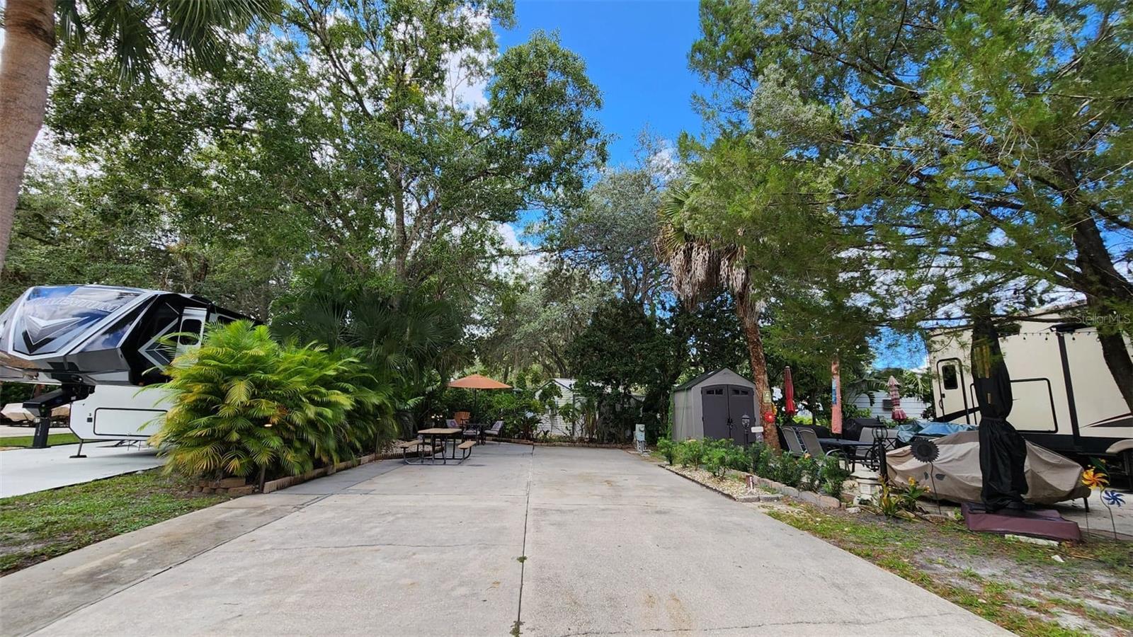 UNBEATABLE OPPORTUNITY! Own your piece of Florida paradise for just $110,000—the most competitively priced lot currently available in the popular River Ranch RV Resort! This fee-simple, deeded lot means NO LOT RENT and true property ownership. Located on the highly sought-after Horseshoe Bend, Lot 153 is the perfect entry-level luxury lot or investment property. This meticulously maintained space offers the ultimate "Old Florida" charm with a perfect balance of mature shade trees, sunshine, and privacy hedges that create a secluded oasis. Enjoy evening dinners under the glow of custom cafe lights in the dedicated dining area, which also includes ample space for golf cart parking. This prime location is just steps away from the resort pools, laundry facilities, and bathhouses for maximum convenience. The quarterly HOA fee covers water, sewer, cable TV, lawn maintenance, trash removal, and 24-hour gated security. Hop on your golf cart and explore the world-class amenities of Westgate River Ranch Resort & Rodeo, featuring the famous Saturday Night Rodeo, a brand-new Water Park, Saloon, airboat rides, and more. This property is lease-friendly, pet-friendly, and has no RV age restrictions. Whether you are a weekend warrior, a seasonal snowbird, or looking for a turnkey rental, Lot 153 is a fan favorite that won't last at this price!