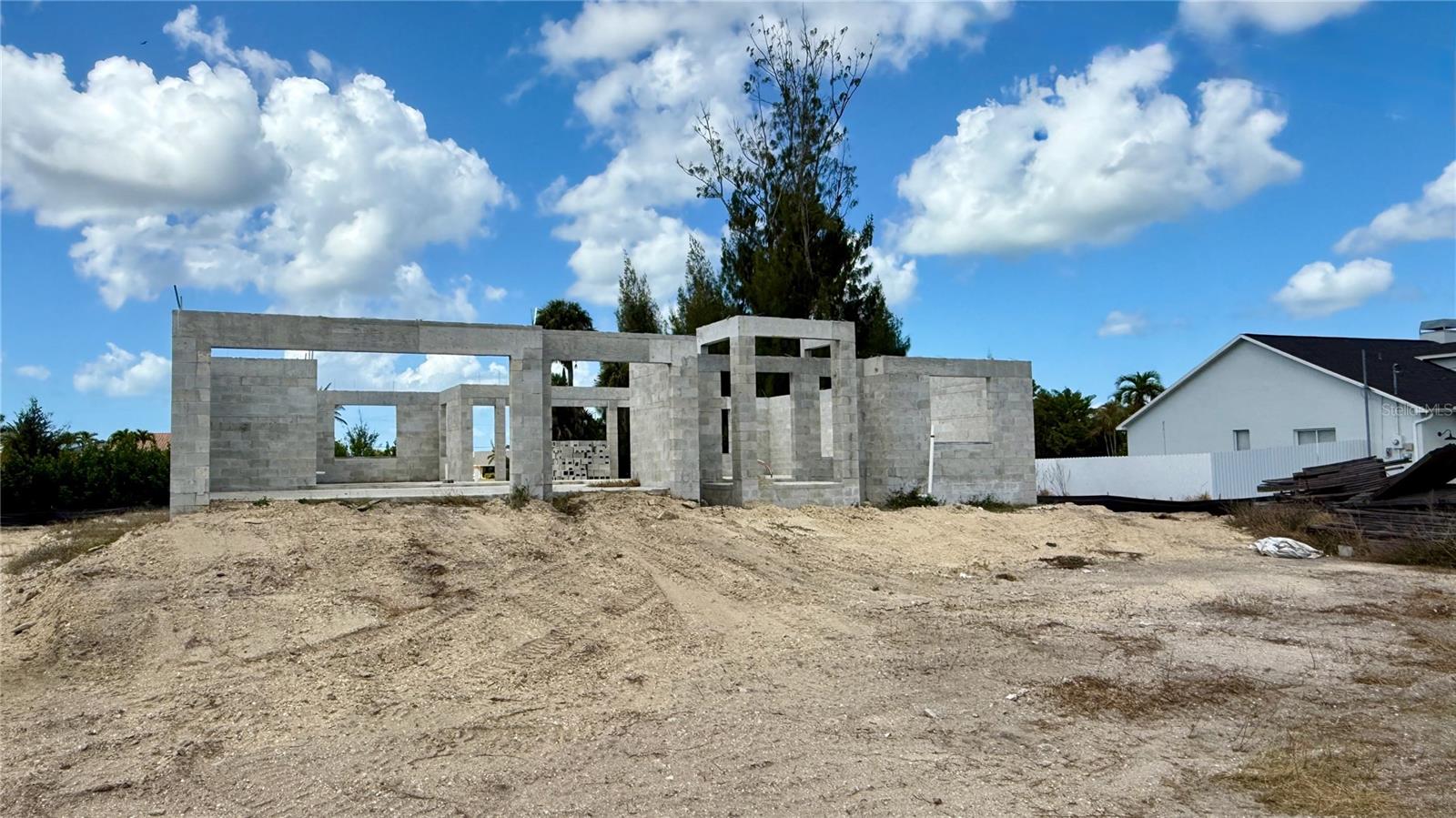 Under Construction. New price. Lower basis. Finish the project your way. Strategically repositioned at $193,700, this as-is, mid-construction Saratoga II model in NW Cape Coral offers a clean opportunity for builders, investors, or hands-on owner-users comfortable completing construction. Planned for approximately 1,831 sq ft of living area and 2,594 sq ft total, the home includes 4 bedrooms, 2 baths, and a 3-car attached garage, with the slab and concrete-block shell already complete. The current stage of construction gives the next buyer a defined starting point while leaving room to control the remaining build-out, finish level, and completion strategy. The full 120 x 125 triple lot totals approximately 0.35 acres and provides added site flexibility for outdoor living, expanded landscaping, or other improvements, subject to buyer due diligence and applicable approvals. No HOA. Well and septic required. The property is sold as-is in its current stage of construction, and the buyer assumes all completion, permitting, utility, and due diligence responsibilities. Available individually or as part of a two-property portfolio with companion listing MLS #C7520228. Construction documents, plans, and permit details are available upon request.
