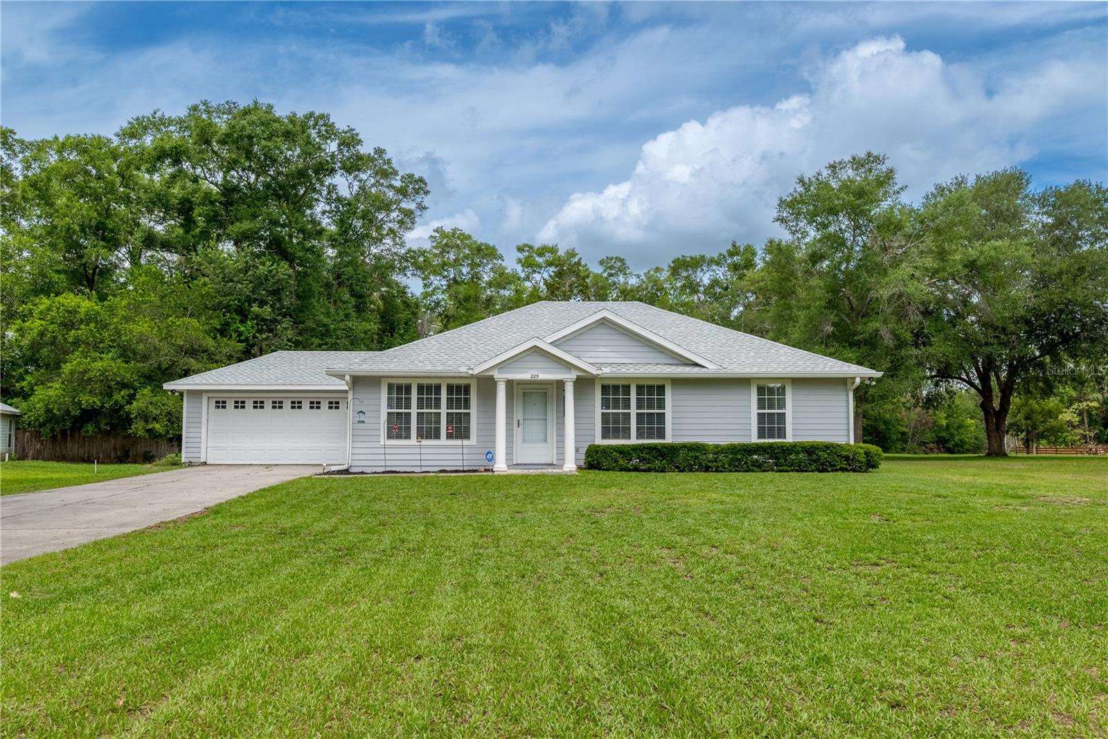 If you are looking for a clean, well-maintained home with room to breathe, abundant natural light and easy access to some of Florida's most beautiful natural springs, this exceptional property is a must-see.  Tucked away on a spacious lot with no rear neighbors, this clean and pristine 3-bedroom, 2-bath home offers the perfect blend of comfort, privacy, and outdoor living. Sunlight pours through the home, creating bright, welcoming spaces that feel warm and inviting from the moment you step inside.  In the ample back yard is a large workshop/shed-a valuable addition perfect for hobbyists, craftsmen, storage, or anyone needing extra space to create and work.  Nature lovers will appreciate the peaceful setting, where deer are frequent visitors to the backyard, adding to the tranquil, country-like atmosphere. Adventure is just minutes away with the crystal-clear waters of Ichetucknee Springs State Park and River Rise State Park only a 10-minute drive from your doorstep.  This property has been meticulously cared for, is move-in ready and even has a roof that is less than 2 years old.  Best of all, there is NO HOA, allowing you the freedom to truly enjoy your property and home comes with a Honeywell generator!  Come see this one before it's gone!