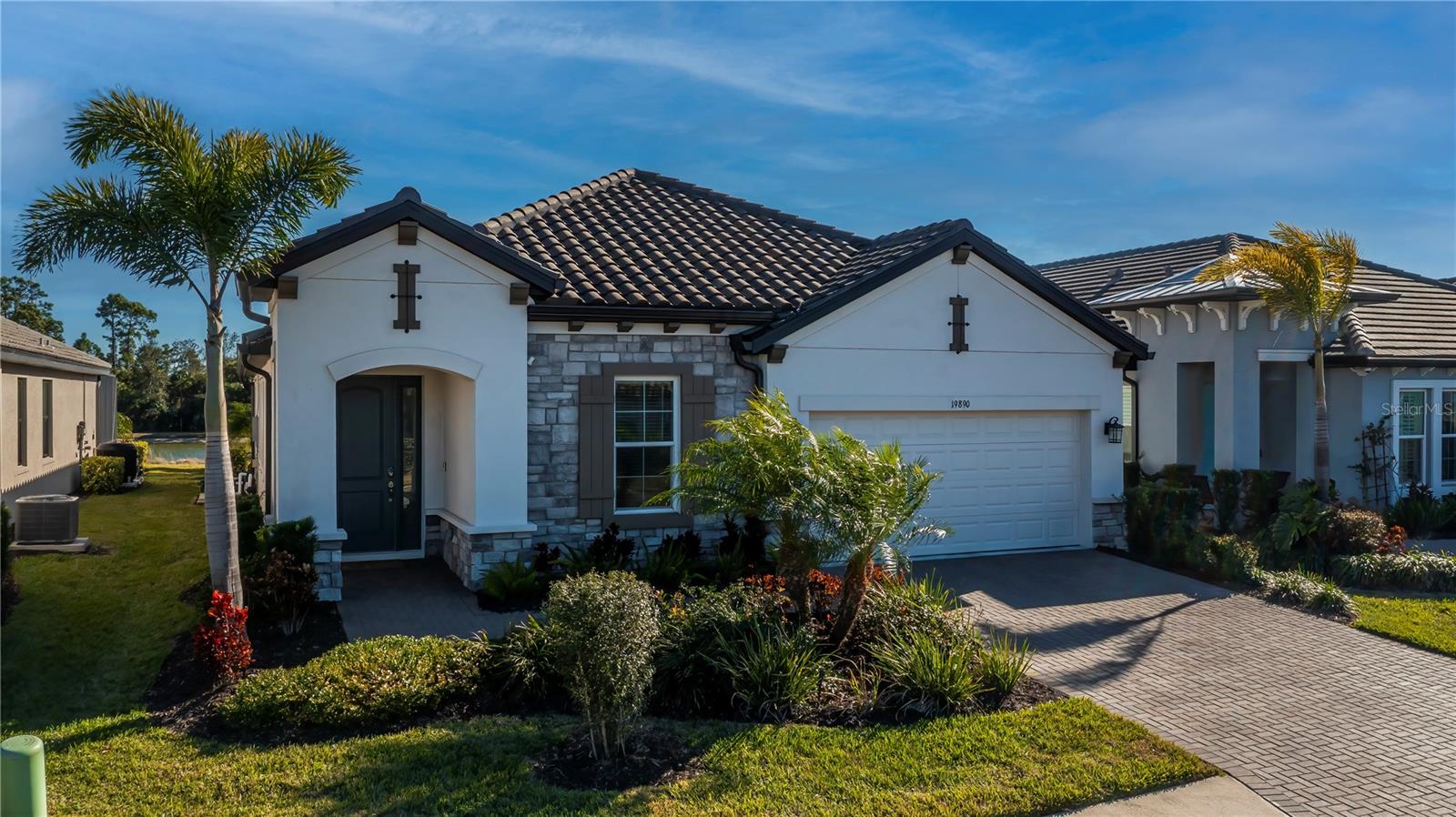 Experience Florida living in this exceptional 4-bedroom, 3-bath POOL home within the gated Oasis community of Wellen Park and is thoughtfully designed to display elegance, privacy, and effortless indoor-outdoor living. From the moment you enter, you’re captivated by tranquil views of a shimmering blue pool, a peaceful pond, and a lush preserve backdrop, creating a truly serene setting.
At the heart of the home, the kitchen stuns with light-gray cabinetry, granite countertops, and an oversized island with sink, perfect for gathering and entertaining. The kitchen includes all stainless-steel appliances such as wall oven, microwave, dishwasher, and a sleek range hood.  The primary suite is impressively spacious and enhanced by a flexible bonus area that could be used for lounging area. The spa-like primary bath showcases his and her sinks, luxurious soaking tub, glass-enclosed shower.
This home’s layout is thoughtfully layed out for privacy. Two guest bedrooms are tucked into their own wing off the kitchen with a shared bath, while the fourth bedroom at the front of the home features its own bathroom, making it perfect for guests, a den, or a home office.
The outdoor living space offers ample room for sunbathing and entertaining, along with a convenient outdoor shower for rinsing off after a swim. Residents of  Oasis enjoy exclusive access to amenities such as a heated community pool, pickleball courts, community clubhouse, scenic walking paths, and the peace of mind of a gated community.
Oasis is a maintenance-free, gated community with secure access to walking trails, dog park, community pool, and pickle ball courts. It is located in the highly sought after Wellen Park which is close by Gulf beaches, shopping dining, entertainment, schools, medical facilities, Atlanta Braves Training Facilities, and the new Wellen Park Costco. Don’t miss the opportunity to make it yours!
