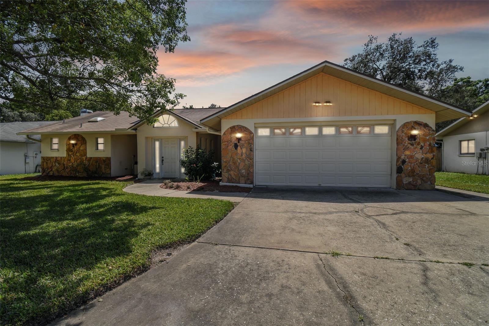 Welcome to your dream home in the beautiful Lakeside Woodlands subdivision of Hudson, Florida! This 4-bedroom, 3-bathroom, 2-car garage pool home offers the perfect blend of comfort and outdoor paradise. As you approach this residence, you will be immediately captivated by its charming curb appeal. Nestled within the serene Lakeside Woodlands community, the well-manicured front yard welcomes you to step inside and explore the wonders within. Upon entering, you will be greeted by a foyer, a sunken living, and dining room that overlooks the pool.  The kitchen has ample counter space and gives you the ability to entertain guest while preparing a casual meal for your family or hosting a dinner party. The kitchen overlooks the spacious family room.  This is the ideal place to relax with family and friends or to unwind by the fireplace.  The four bedrooms in this home are well-appointed, with plenty of space for rest and relaxation. The primary bedroom is a true retreat, featuring an ensuite bathroom with dual vanities, a soaking tub, and a separate shower. The walk-in closet provides ample storage space for your wardrobe. The additional three bedrooms are generously sized, offering versatility for guests, home offices, or hobbies. Two additional bathrooms ensure that everyone has their own space to get ready in the morning. There is an amazing area that could be a nice in-law suite. It includes a bedroom, a full bath, a door out to the pool, plus it has a door that shuts off this entire wing from the home. This home boasts a luxurious pool, perfect for cooling off during the Florida summers. Located in the Lakeside Woodlands subdivision, you'll enjoy a peaceful, family-friendly neighborhood. Hudson, Florida, offers a laid-back coastal lifestyle with easy access to local beaches, parks, shopping, dining, and entertainment options. Don't miss the opportunity to make this 4-bedroom, 3-bathroom, 2-car garage, pool home in Lakeside Woodlands your forever haven. Come experience the best of Florida living and create lasting memories in this exceptional property!!