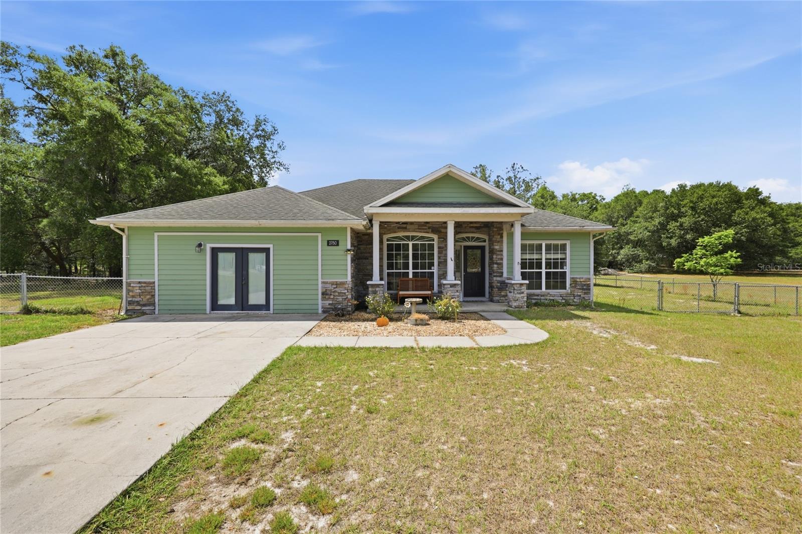 WITH AN ACCEPTABLE OFFER SELLER WOULD REPLACE THE ROOF OR BUYER COULD OFFER ACCORDINGLY.  Discover the perfect blend of space, versatility, and comfort with this beautifully updated 4-bedroom, 3-bathroom home PLUS an office situated on a fully fenced one-acre lot in the heart of Trenton, FL. Designed with flexibility in mind, the converted garage offers a private living area complete with its own entrance, full bathroom, and kitchenette—ideal for multi-generational living, a home office, homeschool setup, student apartment, or guest/in-law suite. Inside, the home features an open-concept layout with updated luxury vinyl plank flooring throughout the main living areas. The spacious primary suite overlooks the backyard and includes a walk-in closet, quartz countertops, and a sunken shower for a spa-like retreat. The remodeled kitchen is both stylish and functional, showcasing quartz countertops, custom wood cabinetry, and stainless-steel appliances. Major system updates—including the HVAC, water heater, and well/pump—were completed in 2022, offering peace of mind for years to come. Enjoy the charm of small-town living with the convenience of nearby amenities. Trenton is known for its strong academic programs and competitive athletics, while being just 40 minutes to Gainesville, 10 minutes to Chiefland, and only 5 minutes to downtown Trenton. Outdoor enthusiasts will appreciate easy access to the Suwannee River and the Gulf of Mexico, both within a short drive. This move-in ready home is ready for new ownership.  Call today for a private viewing.