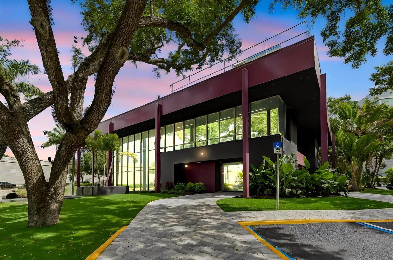 Positioned along one of Tampa Bay’s most traveled commercial corridors, this striking modern office property offers a rare blend of architectural presence, functionality, and long-term investment stability.This two-story, sprawling 8,335± SF office building was thoughtfully designed to make an impression—from the dramatic walls of glass and soaring ceilings to the sleek industrial-modern finishes throughout.

Filled with abundant natural light, the main gathering space creates an energetic and inspiring atmosphere that feels more like a luxury tech campus or design studio than a traditional office. Expansive glass lines, statement lighting, and curated modern interiors combine to create a workspace that is both visually stunning and highly functional.

The layout is ideal for a wide range of professional users, featuring multiple conference rooms, private executive offices, collaborative cubicle spaces, and a stylish common kitchen and lounge area—all designed with productivity, flexibility, and team culture in mind. The property is fully gated, offers abundant on-site parking, and sits on an impressive 1.79-acre parcel in the heart of a thriving business district.

Strategically located along the US Hwy 19 corridor, the property offers exceptional accessibility for commuters throughout Pinellas and Tampa Bay. Employees and clients benefit from immediate proximity to major retailers and dining, including Costco, Super Target, and numerous restaurants just moments away.

Adding to the appeal, the current owner occupies the building and is interested in remaining in place as a tenant after the sale, presenting an attractive opportunity for investors seeking immediate occupancy stability and passive income potential.

Turnkey, architecturally memorable, and exceptionally positioned—this is a rare opportunity to acquire a signature office asset in one of Clearwater’s most active commercial corridors.