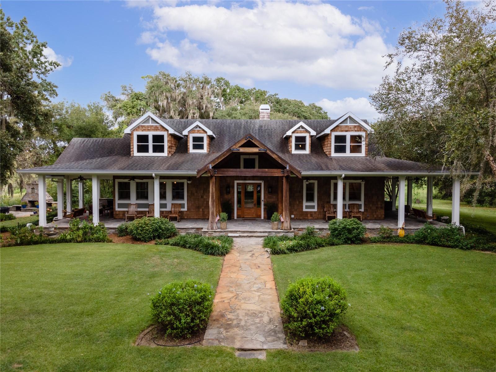 Introducing Quarry Lakes Ranch, a pristine 500-acre retreat located in Bushnell, Florida. This exceptional property features untouched woods, eight picturesque lakes, and a sprawling open pasture, offering a perfect balance of relaxation and recreational activities such as fishing, horseback riding, hunting, and thrilling recreational vehicle/mountain bike routes.

The estate comprises three exquisite homes, starting with the main house. This spacious 3,768 square foot haven boasts a magnificent 1,400+ square foot front porch providing breathtaking views of the shimmering lake. Inside, an open floor plan showcases three charming bedrooms, including a large bedroom hosting multiple beds ideal for guests or a lavish master suite. The rustic yet stylish high-vaulted ceilings and tasteful integration of wood elements create a timeless charm. The main house features a well-appointed kitchen, a convenient gardening/potting shed, and a charming stone patio with an outdoor fireplace.

The guesthouse, built in 1984, offers 1,888 square feet of space and serves as an ideal retreat for family, friends, or as a lucrative vacation/rental property. A spacious front porch treats guests to picturesque views of the expansive pasture and grazing animals.. It includes four tastefully appointed bedrooms, 2.5 baths, a vaulted ceiling living room, and a modern kitchen. Skylights throughout the guesthouse bathe the area in natural light, and a bonus pole barn provides storage space for equipment.

A charming cottage on the property offers intimate accommodations with one bedroom, one full bathroom, and a versatile bonus room, perfect for guests or vacation rentals.

For recreation, Quarry Lakes Ranch features a large-sized pool and hot tub built-in 2020, maintained at the perfect temperature throughout the seasons. The pool house, spanning 2,853 square feet, includes two full bathrooms, an outdoor shower, a kitchenette, a washer/dryer combination, and an entertainment area, ensuring ultimate comfort and convenience. A spacious garage with room for four vehicles and a separate garage for recreational vehicles and equipment are also available. Additionally, there is a structure near one of the lakes that features a tiki bar, outdoor kitchen, and entertainment space. The pool house is equipped with two full bathrooms, a kitchenette, a washer/dryer combination, and an entertainment area, ensuring ultimate comfort and convenience.

The final structure on the property is the barn, offering 2,257 square feet of functional space. It includes an air-conditioned tack room, a half bath, a feed room, and five stalls with automatic water bowls. The fifth stall is larger to accommodate birthing or animals requiring extra care. A cattle pen and chute ensure proper care and handling of livestock.

Quarry Lakes Ranch is a haven for country living, recreation, and entertainment, providing a serene and luxurious retreat for those seeking an extraordinary lifestyle.