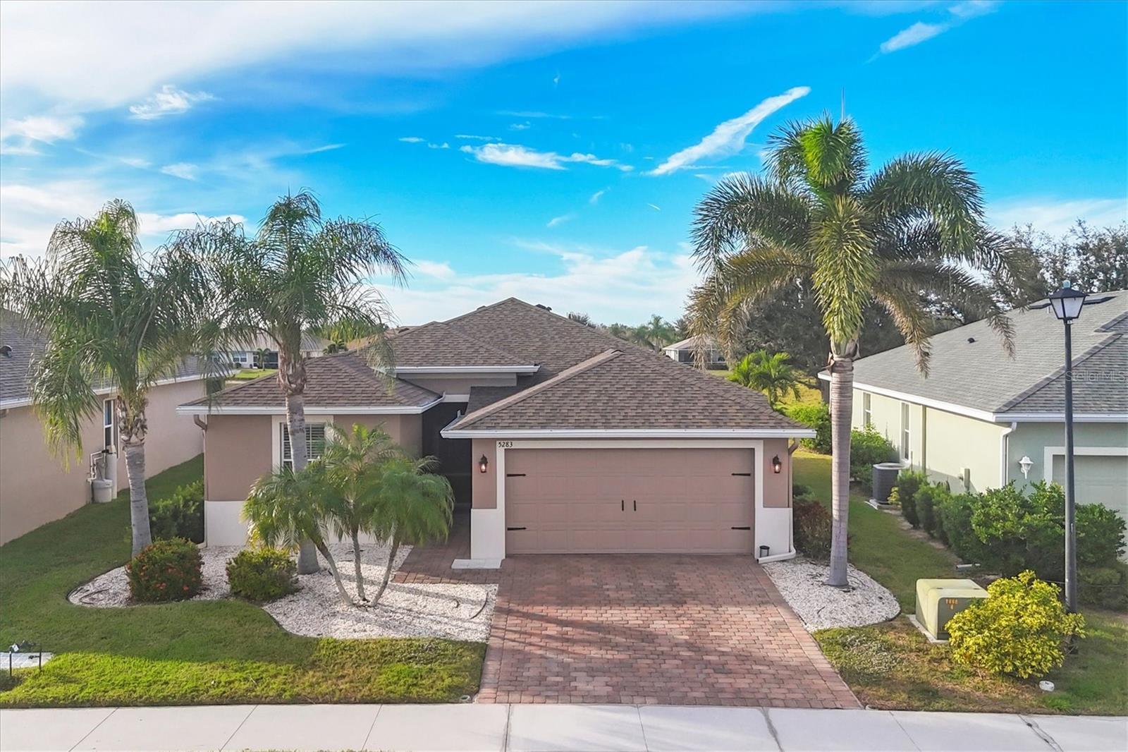 One or more photo(s) has been virtually staged. Beautifully maintained Venice home with a gorgeous lake view!!! There are no CDD fees in Ventura Village, and the HOA dues here amount to less than $95/month. This gated community is very close to Venice, Manasota and Englewood beaches, as well as to an array of shopping and restaurants from which to choose. This 3-bedroom, 2-bath home has a fresh new look and is move-in ready. New carpets were installed in two bedrooms in May 2026, with matching laminate in the third bedroom. Recent upgrades include a new roof (2025), a new AC system (2022), and a new oven and refrigerator (2024). The exterior was painted and new front and rear screens were installed in 2024. This home also features an extended two-car garage for extra storage or workspace The electric panel is set for a generator plug-in with transfer switch for those emergencies, and aluminum storm panels are also included. Best of all, this home offers one of the most beautiful waterfront views in the neighborhood. 
This great home is not to be missed and priced to sell, so call to schedule your private tour soon!