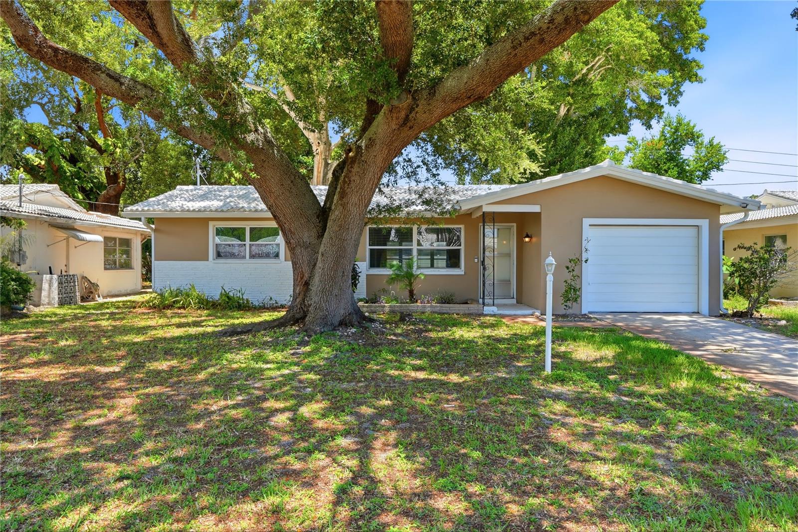 Welcome to this beautifully updated two bedroom, one bath home with an attached one-car garage, ideally located in the highly desirable Greenbriar community. Enjoy an exceptionally low HOA fee of just $271 per year, providing access to the community clubhouse, swimming pool, fitness center, library and game room. Inside, you'll find an inviting open floor plan filled with natural light, creating a comfortable space for everyday living and entertaining. The custom-designed kitchen features updated cabinetry, stainless steel appliances and a clean, modern feel. The bathroom has also been tastefully updated with contemporary finishes. Recent improvements include new luxury vinyl plank flooring throughout, new interior and exterior paint. Step outside to a spacious screened patio overlooking the large backyard, offering plenty of room to relax or entertain. Located in Flood Zone X for added peace of mind and just minutes from Downtown Dunedin, shopping, restaurants, cafés, parks and a short drive to the Gulf Beaches. Come see all this home has to offer!