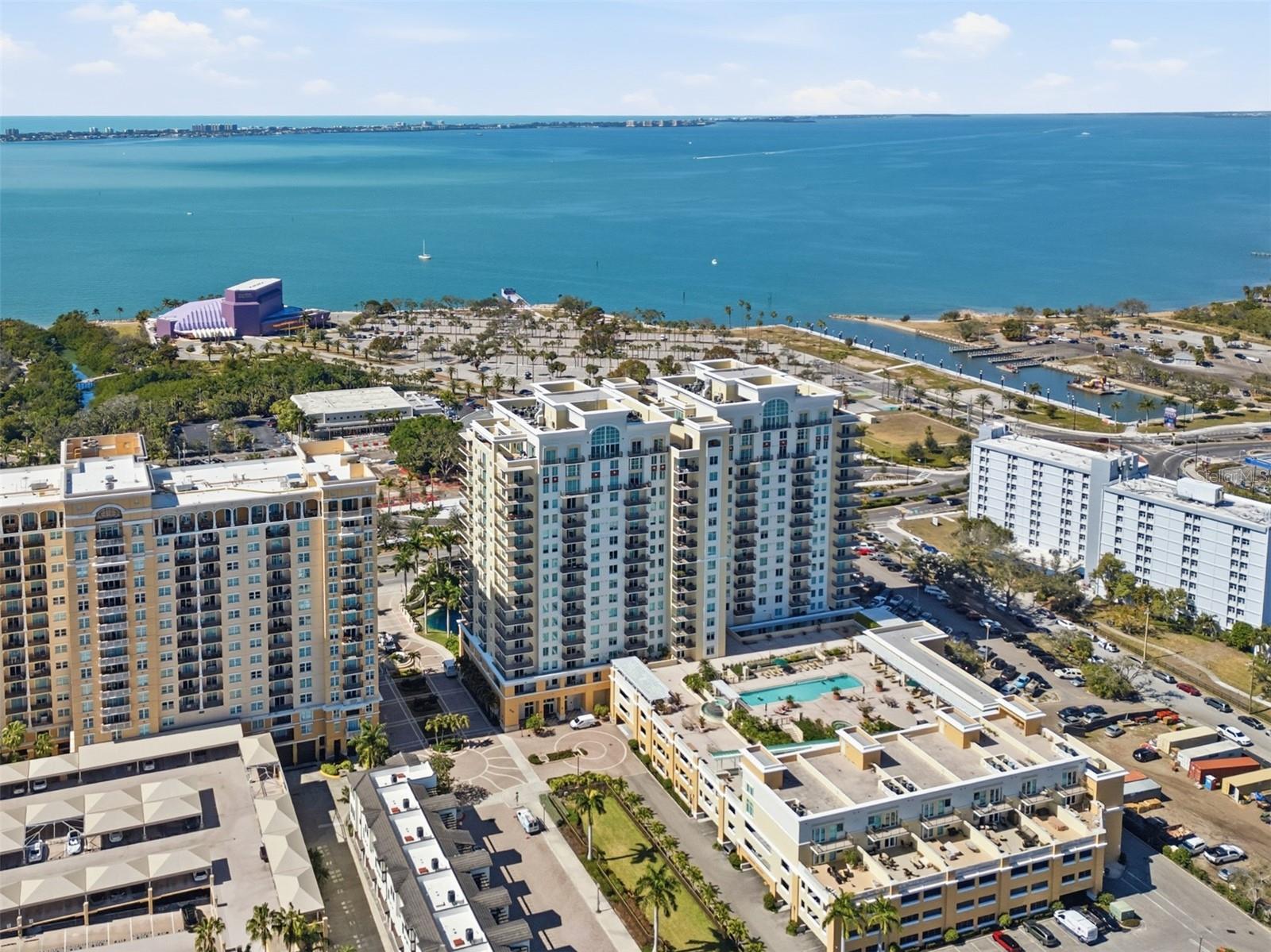 Prepare to be wowed. This expansive water-view and renovated residence on the 12th floor delivers breathtaking Sarasota sunsets and tranquil bayfront vistas the moment you step inside. Thoughtfully designed and impeccably maintained, the home is ideally situated within Sarasota’s cultural epicenter—just steps from world-class performing arts, tranquil garden spaces, the waterfront promenade, and The Bay Park’s scenic walking and cycling paths and multitude of activities. The building itself presents a truly elevated lifestyle, featuring an exceptional array of amenities including a resort-style pool and spa, fitness center with sauna, private theater, billiard room, library, club and tea rooms, business center, wine storage, bicycle storage, private storage, and three guest suites. Residents also enjoy the convenience and security of a 24-hour doorman and two deeded parking spaces.  Inside the residence, refined updates enhance both form and function. Features include fresh paint, newer interior doors with glass knobs, custom closets, and plantation shutters. The kitchen has been tastefully updated with a reconfigured island showcasing a single-level quartz countertop, new sink, and new appliances installed in December 2024. The spa-inspired primary bath and renovated second bath offer a calming, contemporary aesthetic. Major system updates include a 2019 HVAC and a 2017 water heater, ensuring peace of mind. This is elevated Sarasota living—where sweeping water views, walkable culture, and turnkey luxury come together in one exceptional home.