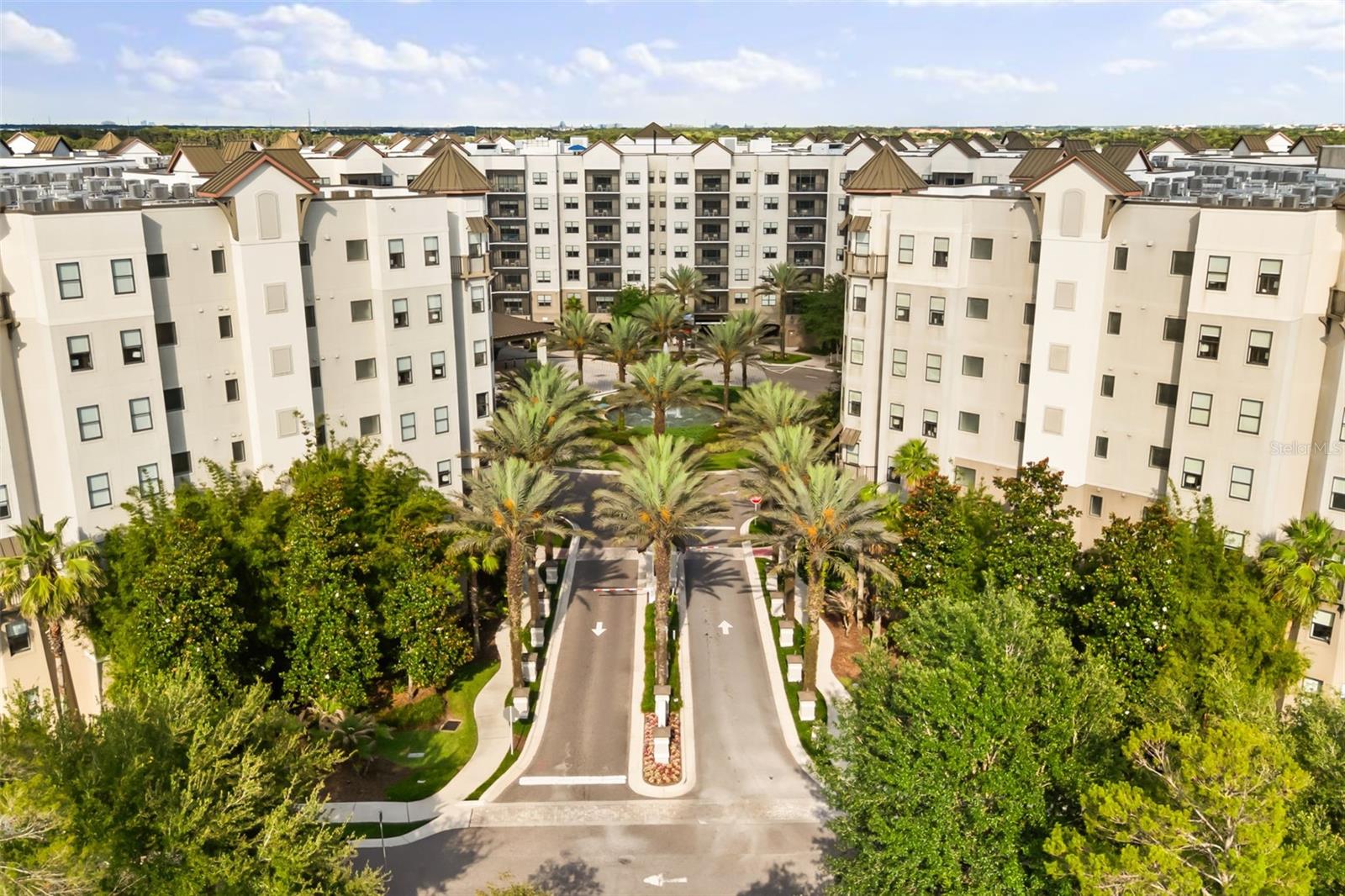 Welcome to this move-in ready condo-hotel residence at The Grove Resort, a world-class, family-friendly destination offering the perfect blend of vacation lifestyle and hands-off investment potential. This bright, modern condo features an open concept layout with natural light, a comfortable living and dining area, and a well-appointed kitchen with warm wood cabinetry, stainless steel appliances, quartz counters, and a breakfast bar. Sliding glass doors open to a private balcony with elevated resort views, creating an easy indoor-outdoor living feel. The spacious primary suite includes a ceiling fan, large window, and en suite bath with dual sinks and a tub/shower combination and a walk in closet, while the secondary bedroom and full guest bath with walk in closet provide flexible accommodations for owners and guests. In-unit laundry adds convenience, and professional on-site hotel management helps handle bookings, guest services, and maintenance. The Grove Resort offers exceptional amenities including Surfari Water Park with a FlowRider surf simulator, dueling water slides, lazy river, splash park, activity pool, zero-entry pool, private cabanas, multiple resort pools, hot tubs, a 20-acre activity lake, private dock, on-site dining, bars, market, arcade, game room, full-service spa, fitness center, and shuttle transportation to Disney World, Universal Studios, and SeaWorld. A strong option for a personal vacation retreat, short-term rental, or income-producing investment near Orlando’s world-famous attractions.