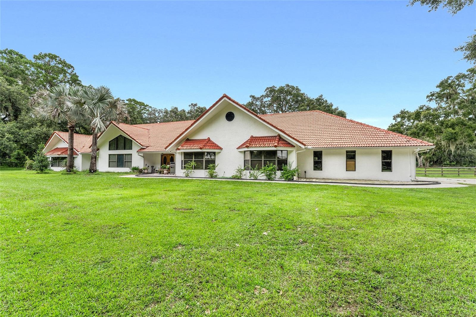 One or more photo(s) has been virtually staged. Top Equestrian Agents Proudly Presents:
“A Perfect Home For Horses & Humans”
This Property captures the essence of Florida Horse Country living…enduring craftsmanship, timeless elegance, and thoughtfully designed equestrian facilities that are nestled in a private, tranquil, 30-acre setting!
Behind a private gated entrance, this stunning 3-bedroom, 2-bathroom estate has everything you could possibly need with soaring ceilings, granite countertops, large walk-in closets, and ample space for the whole family. The outdoor area is expansive, featuring a sparkling screened-in pool and a 23x30 sunroom, perfect for entertaining. Stroll through the custom 10-stall center aisle show barn, take a look around the attached 1-bed 1-bath apartment, or venture out to the generous workshop. Being less than 9 miles from HITS and only 20 miles from WEC, this property won’t last long! Schedule your showing today.