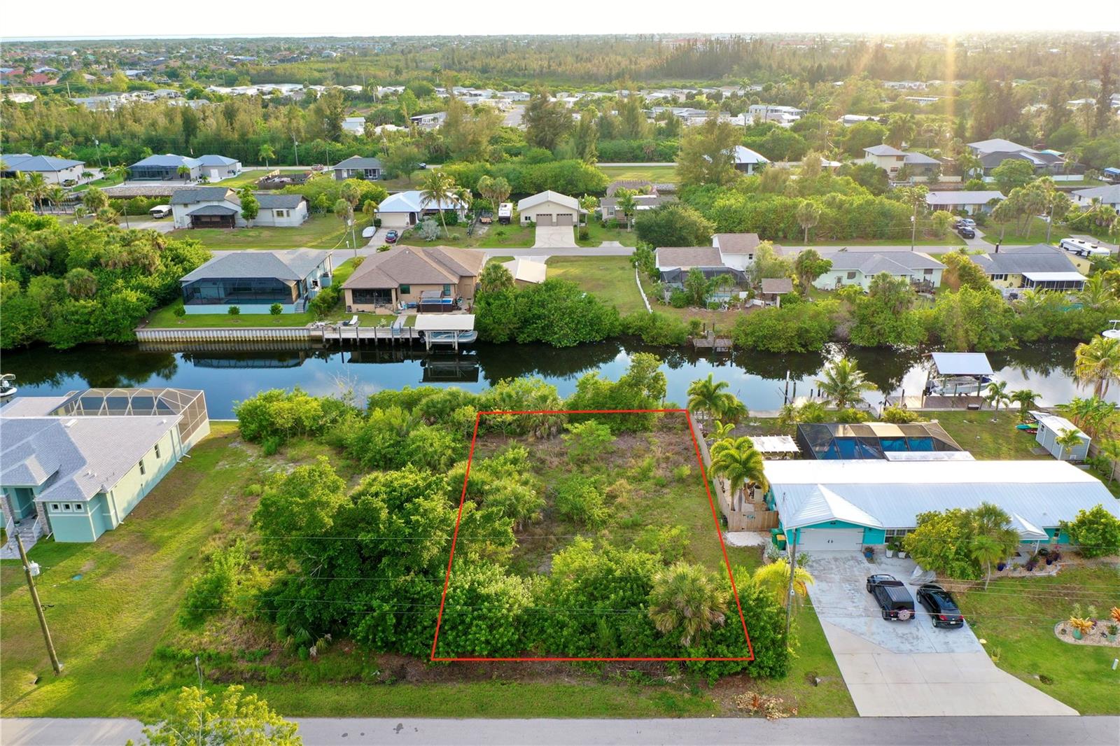 INVEST IN A DOUBLE WATERFRONT-LOT OPPORTUNITY with the adjacent parcel at 3717 Wisteria Place also available separately, allowing you to combine them for an expansive waterfront estate. BUILD YOUR FLORIDA DREAM HOME on this prime WATERFRONT lot situated on a quiet street at 3709 Wisteria Place in Punta Gorda. This highly desirable property features NO HOA and NO DEED RESTRICTIONS, giving you the ultimate freedom to design and enjoy your land. The buildable property measures 75 x 125 feet, offering a generous 9,375 square feet (0.22 acres) of land with 75 feet of road frontage and an impressive 75 feet of direct WATER-FRONTAGE. The footprint of this lot provides ample room to build a spacious custom home while leaving plenty of space to install a pool and sprawling lanai, creating your own private WATERFRONT OASIS to enjoy the sunny Florida weather. A major asset to this property is the existing WOODEN SEAWALL already in place running the full length of the lot, offering immediate shoreline stabilization for your future custom dock and boat lift.

For boaters, this location offers a smooth canal cruise of approximately 15-20 minutes, under 1 bridge (Rio Villa Bridge), out through Alligator Creek, to the open waters of CHARLOTTE HARBOR. From the harbor, you can navigate north up the Peace River, head west to the pristine sands of BOCA GRANDE, or cruise straight out to the GULF WATERS. Public water and electricity are available at the property line, requiring only a septic tank to complete your utility infrastructure. Permitting is straightforward, as county GIS maps confirm the property is completely outside of any protected SCRUB JAY habitat zones, and the National Wetlands Inventory verifies there are NO WETLANDS on site.

The surrounding location balances waterfront living with rapid access to the region's best transportation and recreational hubs. Commuting is effortless with the property located just moments from US-41, a short drive to I-75 for seamless travel north and south throughout the state, and minutes from the PUNTA GORDA AIRPORT for a quick getaway. For dining and convenience, you are just a short drive from HISTORICAL DOWNTOWN PUNTA GORDA, packed with shopping and waterfront restaurants.

Outdoor enthusiasts will love the proximity to nearby parks for hiking. You can catch stunning Florida sunsets at PONCE DE LEON PARK, or head over to GILCHRIST PARK, which features tennis and PICKLEBALL COURTS, a basketball court, and a playground. For the avid golfer, there are different CHAMPIONSHIP GOLF COURSES available for every single day of the week, all within a short drive. Baseball fans are positioned between two Major League Baseball spring training facilities, with the CHARLOTTE SPORTS PARK—home of the Tampa Bay Rays—just a short drive away, and the Atlanta Braves spring training facility in North Port equally accessible. When you want to head to the beach, the shores of BOCA GRANDE and ENGLEWOOD BEACH are both just a straightforward, scenic drive away. This exceptional waterfront lot represents a RARE OPPORTUNITY that merges ultimate building convenience with the finest aspects of Southwest Florida living.