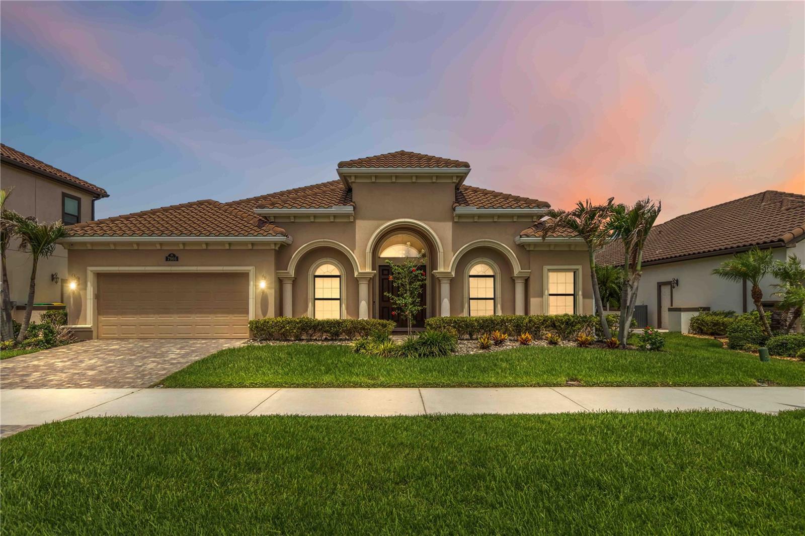 Luxury, comfort, and breathtaking waterfront views come together in this stunning residence within the desired Kerrington at Addison Club. Perfectly situated on a picturesque pond and enhanced by fully paid-off solar panels, this exceptional home delivers an elevated lifestyle with the added benefit of remarkably low energy costs. From the moment you step inside, you're welcomed by an expansive, light-filled floor plan designed for both grand entertaining and everyday living. The impressive great room features built-in surround sound, a statement ceiling fan, and an expansive three-panel sliding glass door that draws your eyes straight to the sparkling water views beyond. The seamless flow leads into a chef-inspired kitchen that is sure to impress, showcasing brand-new top-of-the-line stainless steel appliances, built-in appliances, granite countertops, a striking tile backsplash, a massive center island with bar seating, and an abundance of cabinetry and workspace. The private owner's retreat is a true sanctuary, complete with elegant tray ceilings, a generous walk-in closet, and a spa-like bath featuring dual vanities, a soaking tub, and a separate walk-in shower. The thoughtfully designed split-bedroom layout provides privacy for everyone, while two secondary bedrooms share a convenient Jack-and-Jill bathroom. Step outside and experience one of the home's most captivating features: a spacious screened and covered lanai overlooking the fenced backyard and tranquil pond, creating the perfect backdrop for morning coffee, evening cocktails, or simply enjoying Florida's year-round beauty. Additional upgrades include a tankless on-demand water heater and hurricane-impact windows across the front of the home. Residents enjoy maintenance-free grounds care and access to the renowned Addison Club amenities, including resort-style pools, recreation facilities, BBQ areas, parks, sports courts, and community events. Conveniently located near shopping, dining, healthcare, golf, I-95, and just minutes from the coast. This is more than just a home—it's a waterfront retreat where luxury finishes, thoughtful upgrades, and resort-style amenities create an exceptional living experience. Opportunities like this are rare. Schedule your private showing today and discover everything this remarkable property has to offer. Mortgage savings may be available for buyers of this listing.