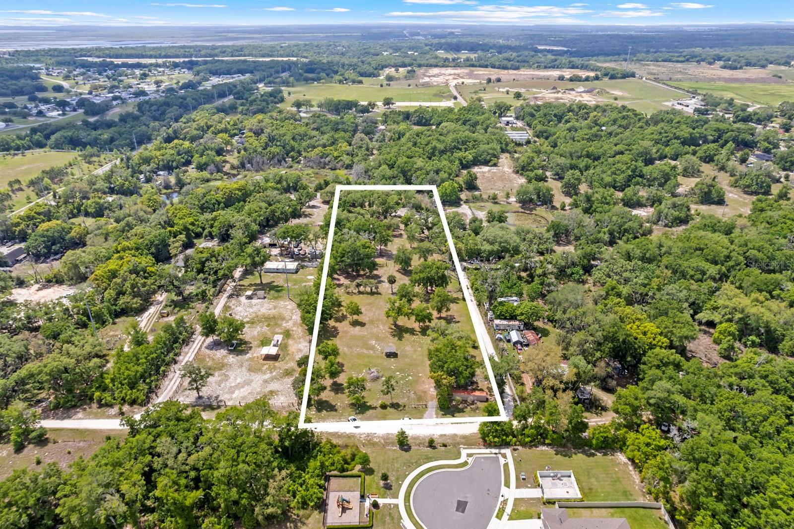 PRICE IMPROVEMENT! Welcome to this exceptional 5+ acre vacant lot, a true blank canvas ready for your dream property. Nestled in a peaceful and scenic setting, this expansive parcel offers endless opportunities—perfect for building a custom home, creating a private retreat, or securing a valuable investment property.

The land features gently rolling terrain, mature trees, and open spaces that together create a picturesque and inviting landscape. With abundant room for privacy, you’ll enjoy a sense of seclusion while still being conveniently close to local amenities and major roadways.

There are multiple potential building sites, offering flexibility in design, layout, and orientation. Utilities are available, including electricity and a water well, helping streamline the development process.

Zoned Agricultural, this property is ideal for horses or a small hobby farm. There is also a large storage unit on-site for your convenience. With over 5 acres at your disposal, there is plenty of space for gardens, outdoor recreation areas, additional structures, and more.

Whether you’re envisioning your forever home or searching for a land investment with exceptional potential, this property is a rare opportunity that delivers both tranquility and versatility.

Don’t miss the chance to bring your vision to life on this beautiful piece of land. Contact us today for more information or to schedule a private viewing.