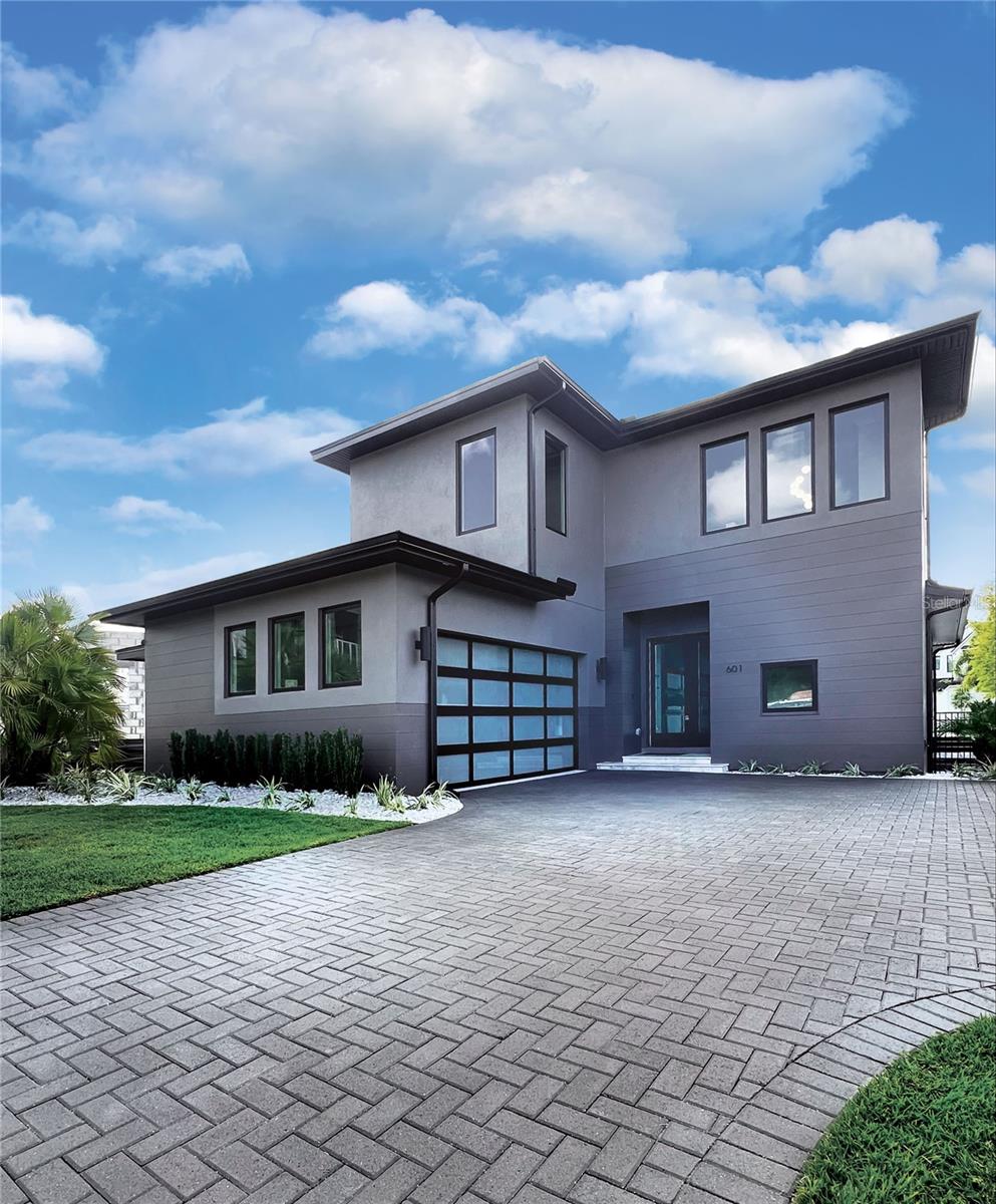 Under Construction. Move in Ready! Take advantage of one of the last chances to live in a new home in Lake Killarney Shores, one of Winter Park's newest communities - a collection of 30 custom homes. Whether you're in the mood for a delicious meal or a shopping spree, Winter Park Village has you covered, and it's just walking distance from this community which makes it all the more convenient for residents. Our community is proud to offer you exclusive access to Lake Killarney through our very own boat ramp. You can now easily launch your watercraft and explore everything that the lake has to offer. Spend your weekends with friends and family soaking up the sun and enjoying quality time out on the water creating unforgettable memories that will last a lifetime. BRAND NEW Stunning Elegant Modern Lake View Home "Serenity" designed by Dan Delong of Origins Residential Design. Pool & Landscape design overlooking pond with fountain. Native Homes "Serenity" features 2,841 heated sq ft. 4 Bedrooms, 4.5 Baths with an additional Summer Kitchen including a Custom Designed Pool and Deck with a BBQ Grill & Custom Stainless-steel Hood. Native Homes "Serenity" also includes a spacious Great Room that natural light enhances. Great Room is pre-wired for a surround sound theatre. Large Kitchen Island topped with “Calcutta” Quartz, Island also has Calcutta “waterfall” sides perfect for dining or workspace WAC with under lighted 42" upper cabinets. Custom Modern Canadian Made “Slab” Kitchen cabinetry with quartz countertops with Carrera Marble Herringbone backsplash, all Bosh Stainless Steel appliances including Bosh Commercial Range. The large Master Suite is on the first floor, its spacious bath has dual sinks, a walk in shower, and a large freestanding Tub. The Laundry & Powder Room complete the first floor. Porcelain tile flooring in Laundry Room and all Bathrooms. All three of the upstairs bedrooms are en suite, all three including their own personal bathroom, walk in closet, and under-mount sinks. Secondary Bathroom includes a 60" soaking tub. There is also a spacious Loft Area on the second floor. The entire home, both floors, feature the same beautiful engineered hardwood flooring & the stairs have stained oak treads, painted risers & wrought iron balustrades. Native Homes "Serenity" has a tankless natural gas water heater an ON-Q system for internet/phone/cable access with pre-wire for full signal Wi-Fi coverage. This home is the ultimate in energy efficiency! Be sure to read the Feature Sheet in Attachments for more detailed information.