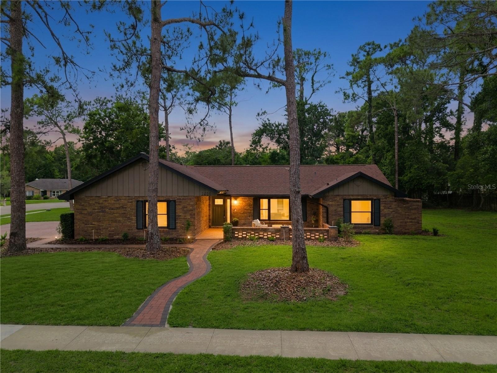 Welcome to 2271 Springs Landing Boulevard, a stunningly reimagined modern residence in the highly sought-after Springs Landing community of Longwood. This fully renovated 5-bedroom, 3-bathroom pool home spans 2,702 square feet, blending elevated contemporary design with timeless luxury finishes throughout.

From the moment you arrive, the home’s striking curb appeal makes a lasting impression with all-new paver driveways,  lush landscaping, and a completely updated sprinkler system. Inside, the home has been thoughtfully redesigned from top to bottom with porcelain tile flooring throughout, contemporary baseboards and doors, and recessed can lighting added throughout the home to create a bright, sophisticated atmosphere.

The heart of the home is the breathtaking kitchen, featuring custom shaker cabinetry, Taj Mahal granite and quartz countertops, designer tile backsplash, under-cabinet lighting, a wine refrigerator, and a massive walk-in custom pantry. The layout flows seamlessly into the living areas, centered around a custom stacked-stone fireplace with Taj Mahal granite hearth, creating the perfect blend of warmth and modern elegance.

This thoughtfully designed floorplan includes two luxurious primary suites, ideal for multigenerational living or hosting guests. The main primary retreat features a custom luxury walk-in closet, individual vanities, and a spa-inspired bathroom complete with a soaking tub and designer-level finishes. An additional bedroom offers flexibility as a home office, gym, or flex space. 

Indoor and outdoor living merge effortlessly through all-new sliding glass doors leading to the screened-in pool and outdoor entertaining spaces. The resurfaced pool, updated tile border, and expansive screened deck create a private backyard retreat perfect for entertaining year-round. Every space throughout inside and out has been beautifully renovated with elevated finishes, including a pool bath featuring a double vanity and custom storage shelving.

Major system updates provide complete peace of mind, including a new roof (2024), new windows, new water heater (2026), new HVAC system (2026), electrical panel updates (2025), and plumbing updates (2025).

Located in the desirable Springs Landing community off Markham Woods Road, residents enjoy proximity to Wekiwa Springs State Park, the Seminole Wekiva Trail, and top-rated Seminole County schools. If you're looking for that "Old Florida" feel while still being centrally located, then this is the home for you! Don't blink - this home is a rare opportunity to own a truly turnkey luxury home with resort-style amenities in the heart of Longwood.