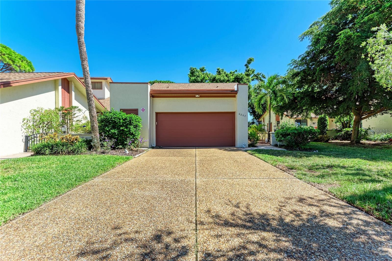 Virtually Staged. Rare opportunity to own this spacious 2,171 sq. ft., 3-bedroom, 3-bath, two-story villa in the desirable Racquet Club Villas. Offering more living space than many single-family homes, this villa provides all the room you need without the hassle of exterior maintenance, as the association takes care of the grounds and exterior for a truly maintenance-free lifestyle.
A charming, paved, enclosed courtyard welcomes you and provides the perfect space for entertaining and relaxing. Inside, you'll find a recently updated kitchen with a breakfast nook, a spacious living and dining area with soaring vaulted ceilings, a wet bar, and a generously sized first-floor bedroom with an en-suite bath.
Upstairs, both bedrooms feature walk-in closets and private en-suite baths. The primary suite also offers newly renovated private balcony, while the large, covered, recently re-screened lanai overlooks peaceful garden views, creating wonderful indoor-outdoor living spaces.
The oversized two-car garage includes a washer and dryer, built-in cedar closet, additional storage under the stairs, and a separate storage room. Lovingly maintained by the same owner for 25 years, this home has been thoughtfully updated throughout (see attached improvement list).
Located in a private community of just 42 villas with a community pool and friendly neighborhood atmosphere, this home is just minutes from IMG Academy, shopping, restaurants, Gulf beaches, and both vibrant downtown Bradenton and downtown Sarasota. If you're looking for the size and comfort of a single-family home with the convenience of maintenance-free living, this is the one.