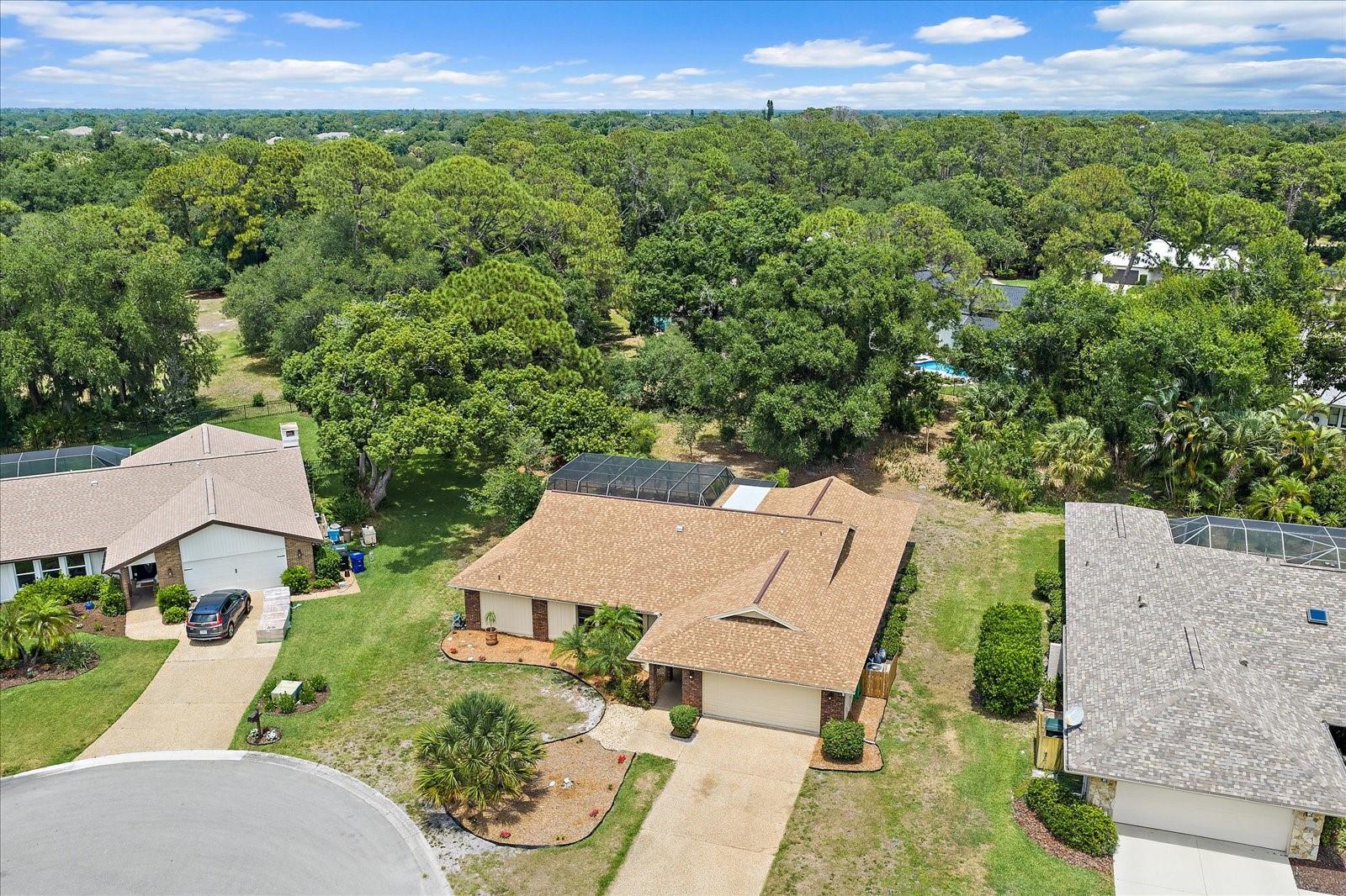 This home is situated on a large private cul-de-sac lot in the highly desirable Bet Tree Village 2 Community.  Updates include a recently rescreened mansard pool cage in 2025 and a the large in-ground pool was just remarcited this year.  A new roof was installed in 2025 and both the interior and exterior of the house has just been painted.  The kitchen has also been updated with wood cabinetry, a storage pantry and granite counter tops.  The SS appliances are new. The kitchen also offers a built-in breakfast bar and sliding glass pass-through windows that open onto the lanai/pool area. The open floorplan is family friendly and features a "split bedroom" layout, with walk-n closets in all the bedrooms.  The large common bathroom also opens to the pool area.  The large family room has vaulted ceilings and a built-in entertainment cabinet.  The living room is also spacious and is adjoins the dining area.  All 4 of the sliding glass doors completely recess as to allow a wide open airy access to the big lanai/pool area.  Bent Tree Village 2 offers a fantastic gated community with winding roads, a community park area and larger than average lots...