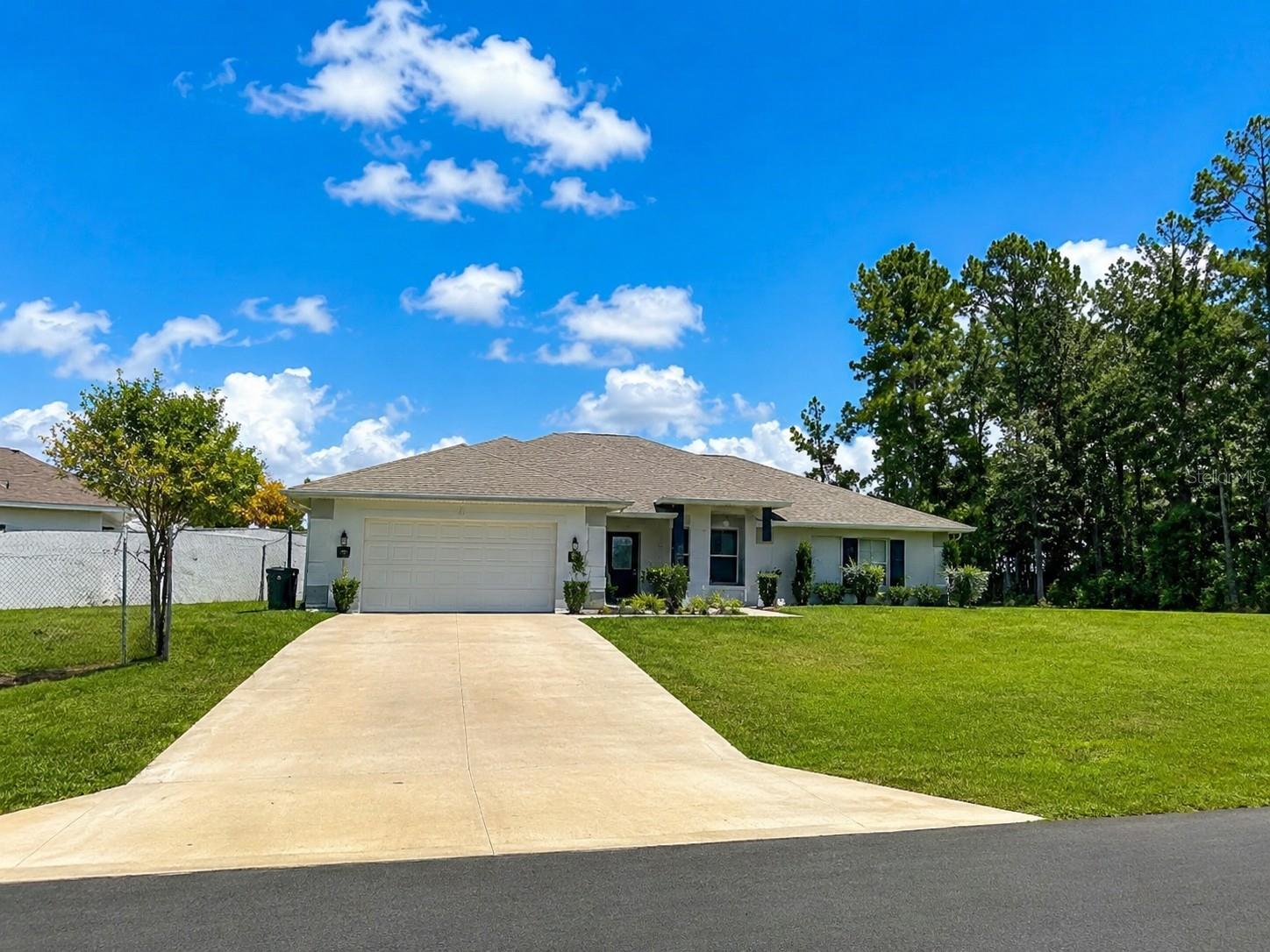 Welcome to this Immaculate and Move-In Ready home situated on a spacious lot in Marion Oaks! From the moment you arrive, you’ll appreciate the beautiful curb appeal, oversized driveway, and peaceful setting with a huge fully fenced backyard perfect for pets, entertaining, or simply relaxing outdoors.

Step inside and enjoy the bright Open Concept floor plan featuring a spacious Great Room, high ceilings, recessed lighting, and stylish finishes throughout. The Gourmet Kitchen is the heart of the home showcasing a Large Center Island with seating, abundant cabinetry, stainless steel appliances, and plenty of counter space — ideal for entertaining family and friends. Dining area flows beautifully into the living spaces creating a warm and inviting atmosphere.

Seller has added many valuable upgrades including Water Softener ($6,600), California Closet shelving in the Primary Bedroom Closet ($2,200), 6’ Vinyl Fence with 2 Gates ($8,275), Gutters, Screened-In Front Entry and Back Porch, Blinds, and Ceiling Fans throughout.
Relax and unwind in the spacious Screened Lanai overlooking the private backyard with plenty of room for outdoor living and gardening. Primary Suite features Ensuite Bathroom with Double Vanity, Soaking Tub, Separate Shower, and Walk-In Closet.

Built with energy efficiency in mind featuring Low-E Double Pane Windows, Energy Efficient HVAC System, R-30 Ceiling Insulation, Energy Star Appliances, and quality block construction. Conveniently located near shopping, restaurants, medical facilities, and major highways. This beautiful home offers comfort, space, upgrades, and exceptional value all in one!

Enjoy access to the World Equestrian Center, Hospitals, Medical Professionals, Theaters, Highways, Downtown Ocala, Restaurants, Entertainment, Grocery Stores, Shopping... Ocala/Marion County is officially named the "Horse Capital of the World®", a testament to the County's unique involvement in all things equestrian and its record of producing some of the finest champions.