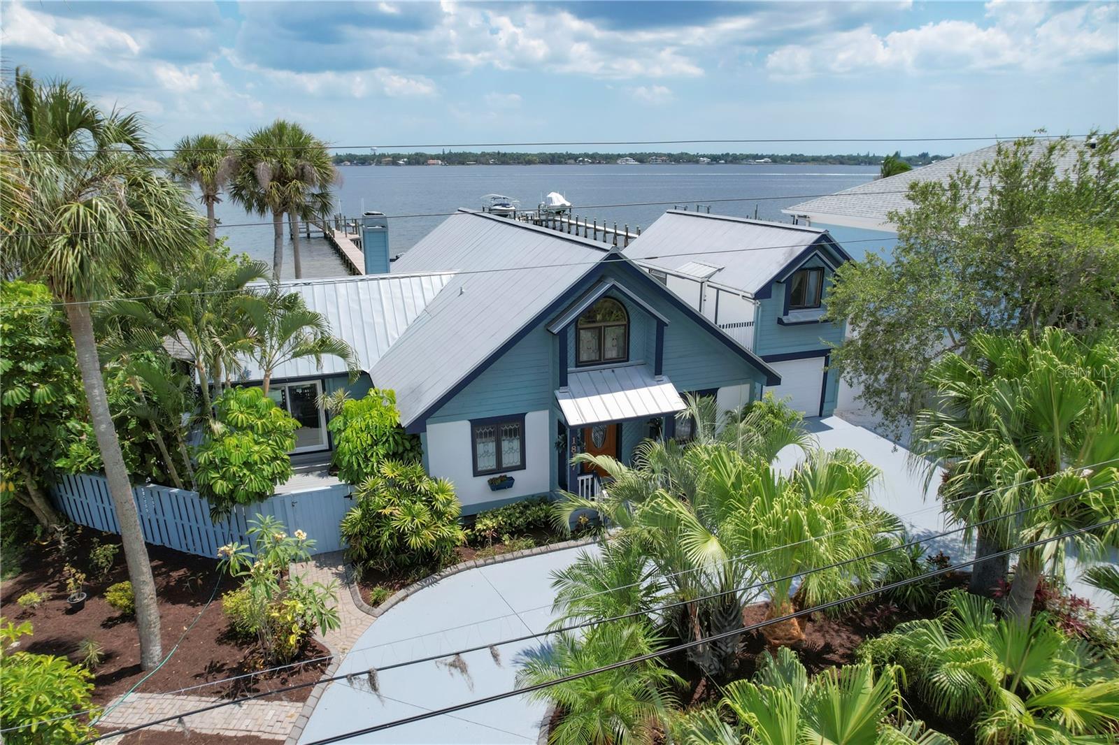This sweet and charming waterfront home is a must-see, positioned on the Manatee River with direct access to the Gulf and no bridges! Meticulously maintained and beautifully decorated, it is offered fully furnished and showcases numerous upgrades throughout. The main residence features three bedrooms and two full baths, along with a unique bonus, a private one-bedroom, one-bath apartment suite above the garage with its separate entrance, ideal for guests or extended family. The tastefully remodeled kitchen includes newer appliances, and addition of an inviting dining room enhances functionality and style. The showstopper is the breathtaking panoramic views of the Manatee River, enjoyed from the living room, dining room, primary suite, and multiple decks surrounding the home, including a private balcony off the upstairs primary bedroom. Go outside and embrace the Florida lifestyle. Relax in the charming gazebo, ideal for shaded afternoons and grilling, or take a stroll down the dock to watch dolphins and manatees play. Cast a fishing line or head up to the two-story sun deck to soak in unforgettable sunsets. Boaters will love the 10,000-pound lift, making this a waterfront retreat. In historic Palmetto, this home is just minutes from a quaint downtown area, marina, dining and a local park. You’re also close to Emerson Point Preserve, downtown Bradenton and a short drive to Gulf beaches, Sarasota, St. Petersburg, Tampa and major airports. Schedule your private showing today. This is Florida waterfront living at its finest, and your personal paradise awaits.