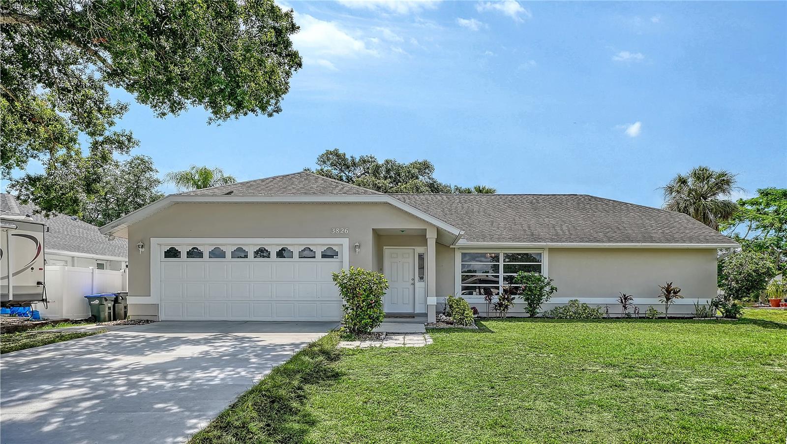 This beautifully refreshed 3-bedroom, 2-bathroom home spans 1,491 sq. ft., this residence offers an inviting atmosphere and peace of mind with significant recent upgrades.  Move right in and enjoy a home that feels like new! The property has been freshly painted inside and out, including the garage, giving it a crisp, clean aesthetic. Functional updates abound, including new toilets, a new washer and dryer, side garage door (impact)  and a brand-new driveway that enhances the home’s curb appeal. New a/c in 2023. The heart of the home features soaring cathedral ceilings in the primary bedroom, living room, and kitchen, creating an airy, expansive feel. The highly desirable split floor plan ensures maximum privacy, separating the primary retreat from the guest bedrooms—making it ideal for families or those who love to host.

Efficiency & Location Enjoy long-term comfort with a new A/C system installed in November 2023. Situated in a great central location, you are just minutes away from local shopping, dining, and major transit routes, putting everything you need within easy reach.