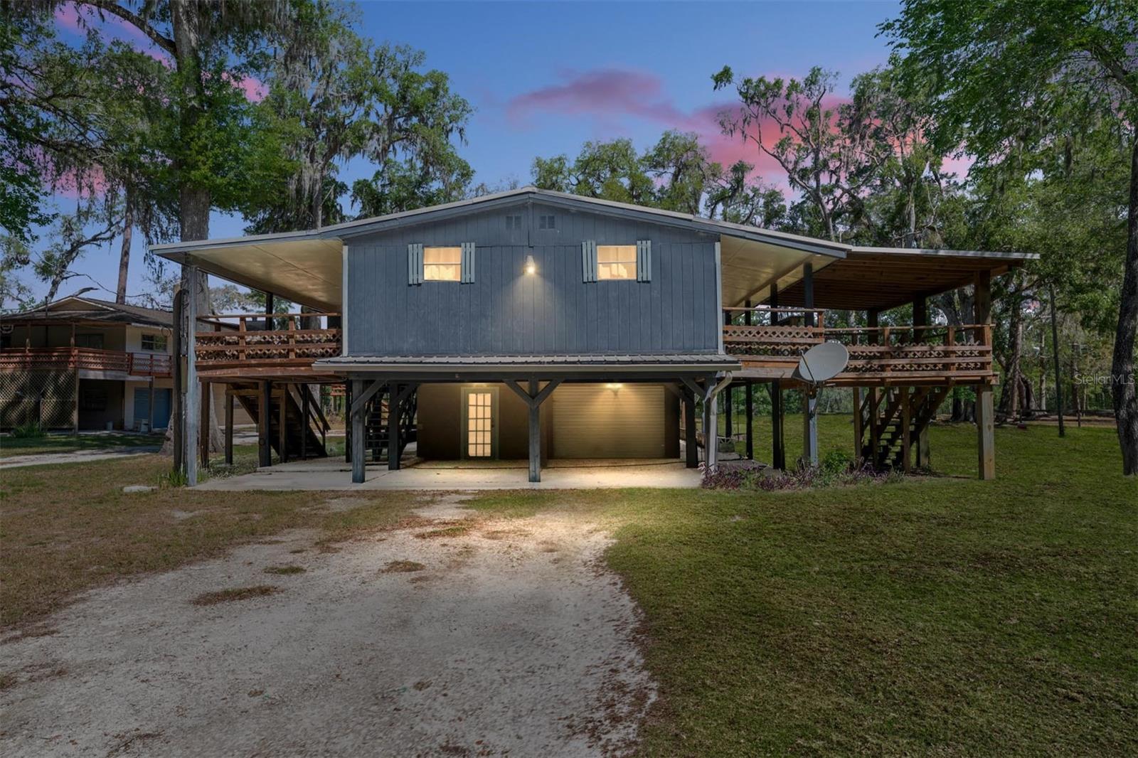 River weekends, boat days, vacation rental potential, and room for everyone — this beautifully renovated river-area home is made for the Florida lifestyle buyers are searching for. Set on a half-acre adjacent to the river, this 3-bedroom, 3-bath property offers the rare combination of move-in-ready updates, expansive outdoor living, flexible parking, and easy public water access right next door.

With approximately 1,564 heated and cooled square feet and an impressive 5,674 total square feet of covered space, porches, parking, storage, and outdoor living areas, this home lives much larger than expected. Whether you are looking for a full-time river retreat, weekend getaway, vacation home, or potential short-term rental income property, this one offers the space and setup to make it work.

Originally built in 1980 and extensively improved with an effective year built of 2011, the home blends character with thoughtful renovations and modern comfort. Inside, buyers will appreciate the updated feel, functional layout, 3 full bathrooms, and the peace of mind of a brand-new HVAC system. The installed freight elevator adds everyday convenience, making it easier to bring up groceries, luggage, coolers, fishing gear, and river supplies.

Outdoor living is where this property truly shines. There is room to entertain, relax on the porches, host family and friends, park boats and trailers, store outdoor toys, or create the ultimate river getaway experience. The generous yard offers plenty of usable space for guests, side-by-sides, kayaks, paddleboards, and recreational gear. The property is located adjacent to the river, with a narrow county-owned/easement strip along the riverbank, and the public boat ramp next door makes launching your boat and getting on the water incredibly convenient.

For buyers searching for a river home, vacation property, weekend retreat, income-producing rental, or flexible Florida getaway, this property checks the boxes: outdoor space, water access nearby, updated living areas, strong entertainment potential, and room for the lifestyle that makes river living so special.

Buyer to verify exact property boundaries, riparian rights, permitted water access, short-term rental rules, and all intended uses. Properties with this much covered space, parking flexibility, renovation quality, and proximity to public boat access are hard to find.
