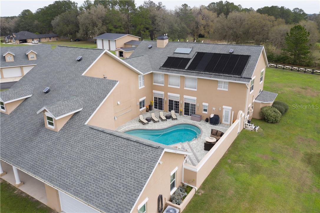 Location, Location!!! Minutes to HITS and just a short drive to WEC, this farm boasts 2  homes for the extended family, your trainer, or use it as a rental for added income.The 30 acre property features a main residence of +- 7000 sq. ft., with 5 bedrooms, 4 bathrooms, an in-ground pool, a 5 car garage. The truly stunning chef’s kitchen with a large gas range and a plethora of cabinets is a kitchen made to entertain the whole extended family & friends. Stone fireplaces, high ceilings, and natural wood accents throughout the home impart an upscale lodge feel. This home also features a personal elevator to the second floor of the home where you will find additional bedrooms and also a great entertainment room for the whole family. 
The second home with a generous 2,890 sqft of living space has its own entrance via the backside of the property. An additional building has room to house 5 cars and features a 2bed/2bath upstairs apartment of +- 1,200 SQFT of living space.  Ancient majestic oak trees provide shade and beauty to the pastures and lawns, one of Ocala’s symbols of our gorgeous thriving ecosystem. The  cross fencing is a picturesque amenity to the property, and being only 3 miles from HITS and a short drive to WEC, the property is in a great location to be a working horse farm. 1600 feet of road frontage has been cleverly equipped with a berm mitigating road noise. Don’t miss out on this lush 30 acre property. Call today for a showing.