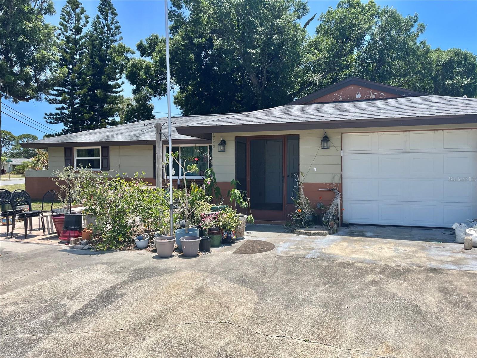South Venice opportunity!! This home is full of potential with many major repairs and replacements done for you. Newer Impact windows! Roof only 2 years old! Newer AC! Remodeled kitchen! House has also been repiped! Enclosed sunroom can be used as an office, den or even a guest bedroom! The primary bedroom suite has a walk-in shower. The guest bedroom also has a private bathroom. Some cosmetic love is needed, but this home has great bones, an attached garage, a lovely garden and outdoor patio, and a circular driveway. There is also a shed in the back yard. The location is convenient to shopping, dining, entertainment and historic downtown Venice. Membership in South Venice Civic Association offers access to a boat  ramp and ferry to your own private beach! Perfect for kayaking and fishing. No HOA or CDD fees!!!