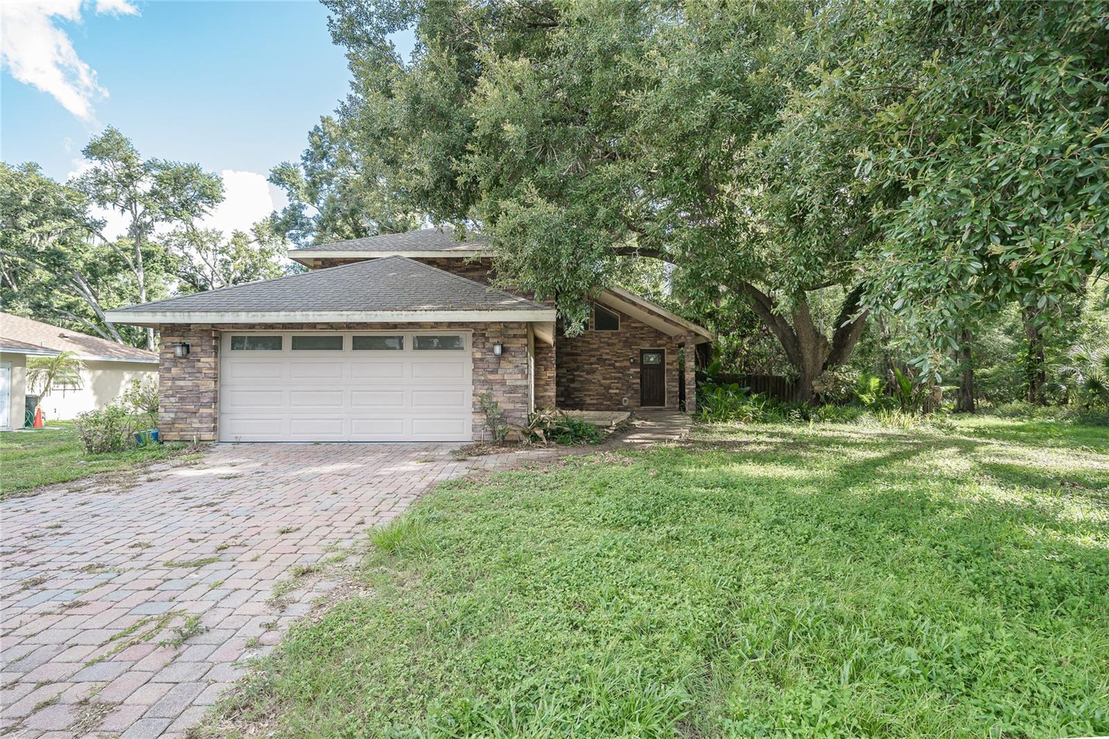 Short Sale. SHORT SALE. Here's an opportunity to restore this oversized wooded home on a private, lot at the end of a quiet cul-de-sac. Located in one of Carrollwood's most desirable established neighborhoods. Offering exceptional potential, this home is ideal for investors, renovators, or buyers looking to customize a home to their own style. Inside, you'll find vaulted ceilings, an open-concept floor plan, a beautiful stone fireplace, and a spacious loft overlooking the main living area.The first-floor primary suite provides added convenience, while two additional bedrooms are located upstairs. The generous kitchen offers plenty of cabinet storage, and the air-conditioned Florida room provides additional living space for year-round enjoyment. Large windows throughout the home fill the interior with natural light and showcase peaceful views of the private backyard. The oversized lot offers both privacy and ample space for outdoor entertaining or future enhancements.  Detached shed and the gazebo are equipped with electricity, adding flexibility for a workshop, hobbies, storage, or outdoor gatherings. Conveniently located near shopping, dining, parks, and major roadways, this home is full of possibilities and ready for its next chapter.
Short sale is subject to lender approval.