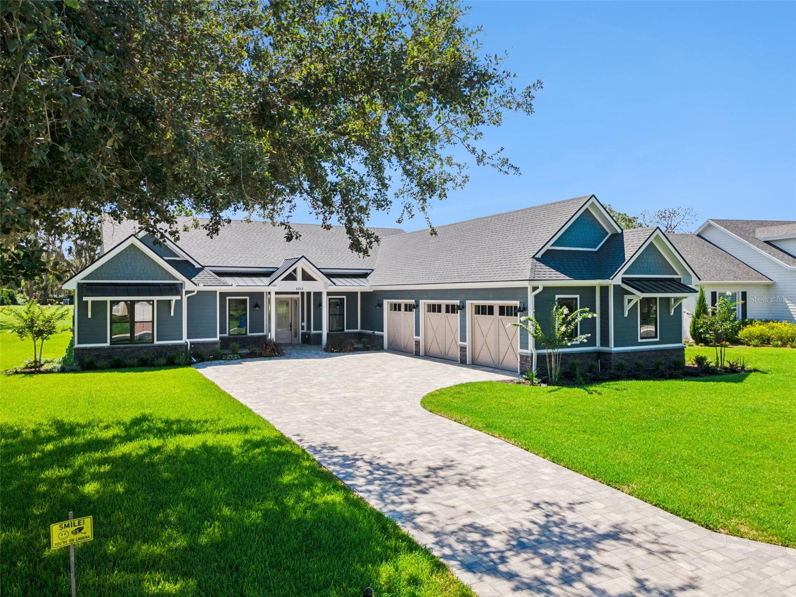 Virtually Staged. Brand New 2026 Custom Farmhouse Blends Modern Luxury with Exceptional Craftsmanship.
Welcome to 4050 Palma Ceia Circle, a stunning new construction one story farmhouse estate located within the gated Cypresswood Golf & Country Club in Winter Haven, Florida. Perfectly positioned on an almost half acre double front golf course lot, this exceptional residence offers the ideal combination of luxury, quality craftsmanship, and modern convenience. Thoughtfully designed for comfortable living and effortless entertaining, this home features 3 bedrooms, 3.5 bathrooms, a dedicated home office, elegant tray ceilings, luxury tile flooring throughout, and an open concept floor plan filled with natural light. The chef's kitchen is the heart of the home, showcasing a large center island, solid wood cabinetry, a generous walk in pantry, a dual fuel stove, and premium finishes that flow seamlessly into the living and dining areas. The primary bedroom offers a peaceful retreat with a large walk in closet and a spa inspired bath featuring a soaking tub and a beautifully tiled walk in shower. Step outside to the paver patio, complete with a fully equipped outdoor kitchen and outdoor shower, creating the perfect setting for relaxing or entertaining year round. Built with exceptional quality and energy efficiency in mind, the home features Huber ZIP System sheathing, James Hardie pre finished siding, Therma Tru exterior doors, an Atlas roofing system, Andersen double pane windows, and two tankless water heaters. The attached three bay garage includes attic storage above and is pre wired for a Level 2 EV charger and generator, offering future ready convenience and peace of mind. Residents enjoy resort style amenities including the 18 hole Ron Garl Championship Golf Course, junior Olympic swimming pool, tennis courts, pickleball courts, fitness center, clubhouse, restaurant, and bar. Conveniently located near Highway 27, I 4, and the Polk Parkway, this exceptional home provides easy access to Orlando, Tampa, Lakeland, and Central Florida attractions. Experience luxury golf course living at its finest. Schedule your private showing today.